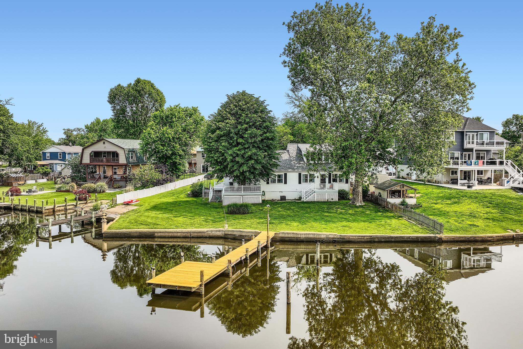 ***OPEN HOUSE - SUNDAY, JULY 27th 2:00 PM - 3:30 PM. *** Breathtaking Waterfront Retreat on Jones Creek! Welcome to your private oasis in the heart of Sparrows Point, a rare opportunity to own a spectacularly renovated single-family home offering approximately 140 feet of panoramic waterfrontage on .33 acres of pristine shoreline. This stunning property features two piers, a private boat ramp, and breathtaking views from nearly every room, creating the ultimate waterfront lifestyle experience. Step inside to a light-filled foyer with immediate water views, a convenient half bath, and laundry room. The open-concept main level invites you into a gourmet chef’s kitchen complete with granite countertops, under-cabinet lighting, stainless steel appliances, cooktop, built-in oven and microwave, crisp white cabinetry and stunning backsplash. The large kitchen bar offers plenty of seating, and the adjacent dining area flows effortlessly into a spacious living room with a cozy sitting nook, all designed to showcase stunning water views. From this space, step out onto the first of two expansive decks, where you can soak in the waterfront breeze and take in truly unforgettable views. The upper level features two generously sized bedrooms and a beautifully updated custom tiled full bath. What makes this property truly unique is its flexible layout, ideal for large families or multigenerational living. Off the main living area, a separate wing includes a massive family/rec room/dining area with vaulted ceilings and sliding glass doors that lead to a second waterfront deck, perfect for entertaining. Here, you'll also find a luxurious full bath with a jetted tub and custom-tiled walk-in shower, and an exceptionally renovated second kitchen, never used, all brand new, featuring vaulted ceilings, granite countertops, white cabinetry, stainless steel appliances, custom backsplash, a spacious bedroom with walk-in closet, all with water views and a private upper-level bedroom complete the space with brand new egress skylight window, flooding the space with natural light! This wing offers its own separate entrance with a ramp, making it ideal for an in-law suite, guest quarters, or private family living. Throughout the home, you’ll find all-new luxury vinyl plank flooring, blending durability with high-end design. Additional highlights include an attached garage, a spacious driveway, a covered carport, and a partially fenced yard. The recently waterproofed basement offers an oversized storage area for all your needs. This home boasts two dual HVAC systems for efficient climate control, a 6-year-young roof, a new main pier with fresh decking, new pylons and electrical hookups. A second pier, just five years new, complements the property, both ready to accommodate your boat, jet skis, or simply enjoy peaceful waterfront living. And when you’re ready to explore, hop on the paddle boat for a magical ride along the creek, just minutes from the brand-new Sparrows Point Park. Enjoy a full day of activities, from playgrounds and scenic walking paths to storytime and music & movement for your little ones, as well as activity rooms, a community center, athletic fields, and so much more, all just minutes from your dock. Whether you're entertaining on the dual decks, launching a boat from your own ramp, or simply unwinding by the water, this exceptional home delivers a lifestyle few can match. A true waterfront gem-inside and out. From boating adventures to sunset dinners on the dual decks, or simply unwinding with the gentle sounds of the water, this exceptional property invites you to live the waterfront lifestyle to the fullest. Truly a rare find, where comfort, beauty, and location meet. So, what are you waiting for? Come take a tour, fall in love, and make this enchanting waterfront retreat the next chapter in your story!!!