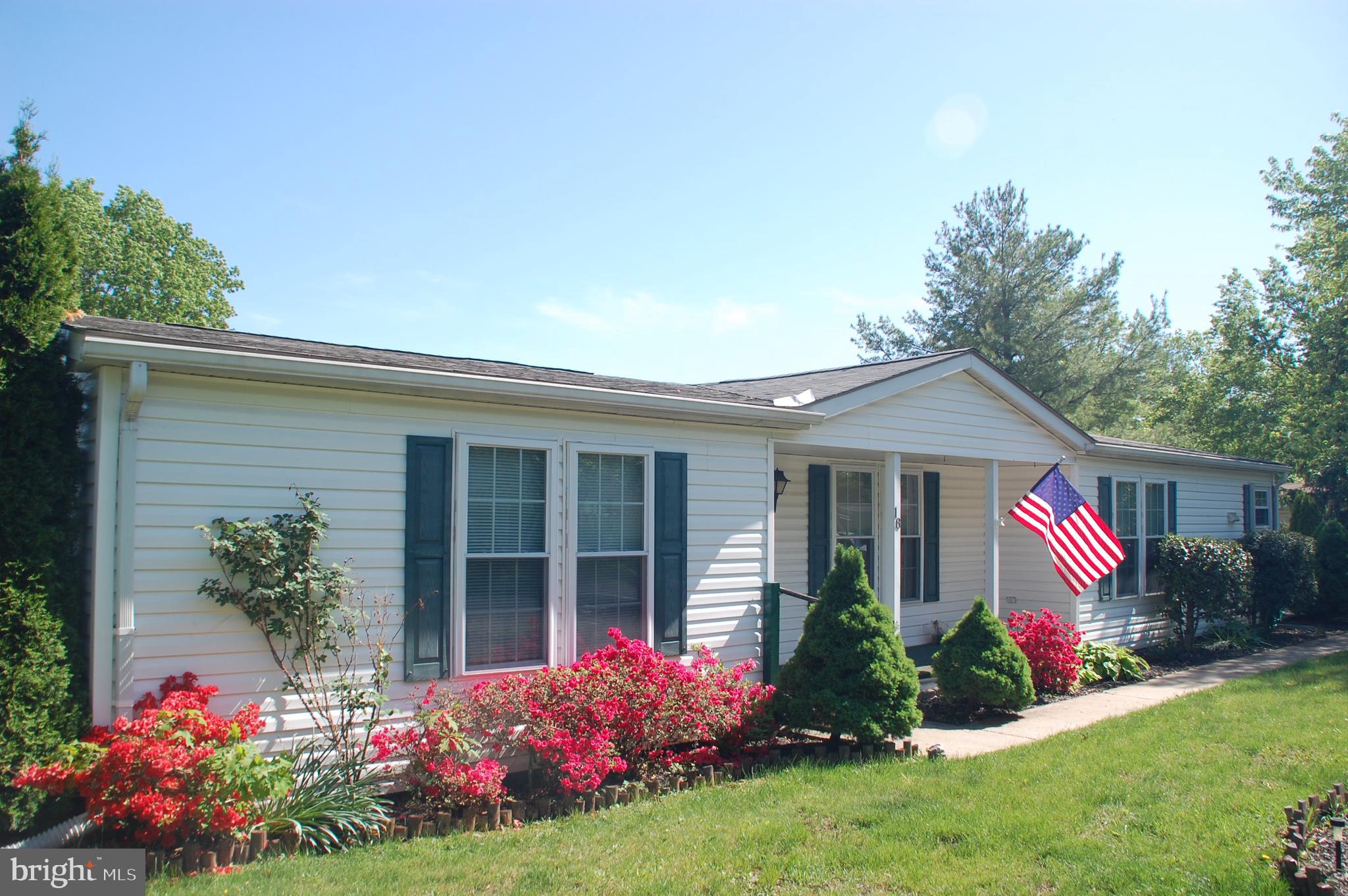 If you've been waiting for a rarely-offered 3 BR home in the popular Hidden Springs 55+ community, your wait is over! This very clean 3 BR, 2 Bath home is situated on a large corner lot and has many features beyond that. Entering the home from the covered front porch (17' x 4'), you will find a spacious LR with a beautiful brick Fireplace - another amenity not commonly found in Hidden Springs homes. You will find BRAND NEW carpeting in the LR, Primary BR and BR 2. An improvement that adds convenience and safety is the low threshold shower in the updated hall Bath. This home offers a formal DR as opposed to the standard LR - Kitchen combination. The DR includes a large, illuminated built-in china cabinet. The Eat-in Kitchen has an abundance of cabinets, two of which have lighting features, and stainless steel appliances. You will love the Primary BR with walk-in closet and Primary Bath with ample vanity and cabinet storage, a tub/shower arrangement plus a separate stall shower. There are two additional BRs, both with walk-in closets, and a hall Bath. A 15' x 13' side patio is anchored by the upper shed (8' x 8') and the lower shed (8' x 4'). Two Sheds is another point of distinction for this home. There's lots to see here - come check it out!