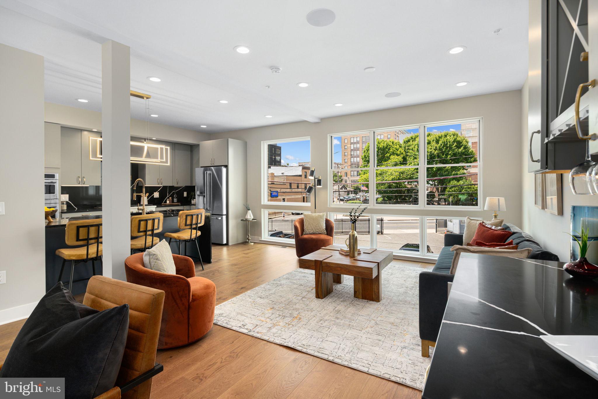 PHASE 2 SELLING NOW! WOW $25K credit offered toward builder upgrades! Positioned between Fairmount and Northern Liberties is The Residences at Park Avenue, a community of 13 semi-custom 21.5' ultra wide homes. For a limited time, these homes are available at a pre construction price with opportunities to customize. Statement-making lighting pieces hover proudly as you enter the first floor where you’ll find a bedroom, full bathroom, and bright office area. Wood flooring, designer light fixtures, and strategically placed accent lighting are just a few of the high-end features that adorn these homes. Heading upstairs you will find the open concept floor plan that allows the living and kitchen areas to blend seamlessly together. Exploring every corner of this floor, you will discover convenient features designed for entertaining and everyday life. The kitchen area features a quartz island with optional elegant under-counter lighting and tambour paneling, GE appliances, and soft close cabinetry. To create intimate evenings with family or friends, opt for the built in Sonos speaker system, smart lighting controls to dim the lights, and craft a cocktail at the built-in beverage & wine station. Then open the sliding doors off the living area to your second floor patio to enjoy an evening under the stars, a space perfectly suited for morning pastries and coffee to grilling and cocktails. The third floor bedrooms are bright open spaces that can be upgraded with custom closets and smart lighting systems. Entering the main bedroom you’ll love the spa-like bathroom with finishes thoughtfully selected by professional designers, optional heated floors extending into the shower, and a frameless glass shower. Finally, the fourth level is your outdoor oasis– a 400+ sq ft deck with views of Center City and Northern Liberties. Choose to furnish this space with a pergola, decorative string lights, outdoor Sonos speakers, and accent lighting for a truly turn-key outdoor area that will inspire your next alfresco dinner or intimate soiree. With tech & security features that can create the foundation for a true “smart home” ecosystem, your wildest Alexa and Google home capabilities come to life. Complete this setup with electricity & water meter monitors, smart door locks, wifi boosters, and a 2Gig Edge All-In-One-Interface– every inch of this home can be prepped to create end-to-end technology experiences. At The Residences at Park Avenue, you have the best of both worlds, one where you have instant access to sophisticated dining and an urban feel. Hop on the Broad Street Line and see a show, or remove yourself from the hustle of the city in the greens of Fairmount Park. Steps away from your front door are convenient everyday spots like Aldi, Santucci’s Pizza, and numerous cafes or coffee shops. After your day is over, a convenient night out at The Met, Osteria, Cicala, Thirsty Dice or the speakeasy at the Divine Lorraine are all within a 5 minute walk. Notable standard features of these homes include a double carport, 9ft ceilings, a finished basement, and a tax abatement! Buyers can also choose to take their home to the next level with optional upgrade packages that include curved waterfall islands, outdoor decks, indoor and outdoor Sonos speaker systems, electric vehicle charging stations, smart lighting, tankless water heaters, wine & beverage centers, GE Cafe appliances, and much more. A la carte upgrades can include electric vehicle charging stations, additional powder rooms, and pantries. Contact us for a detailed view of the upgrade packages. Don’t miss your chance to own one of these incredible homes at The Residences at Park Avenue. Total square footage includes a fully finished 711 sq. ft basement. Schedule your showing today!