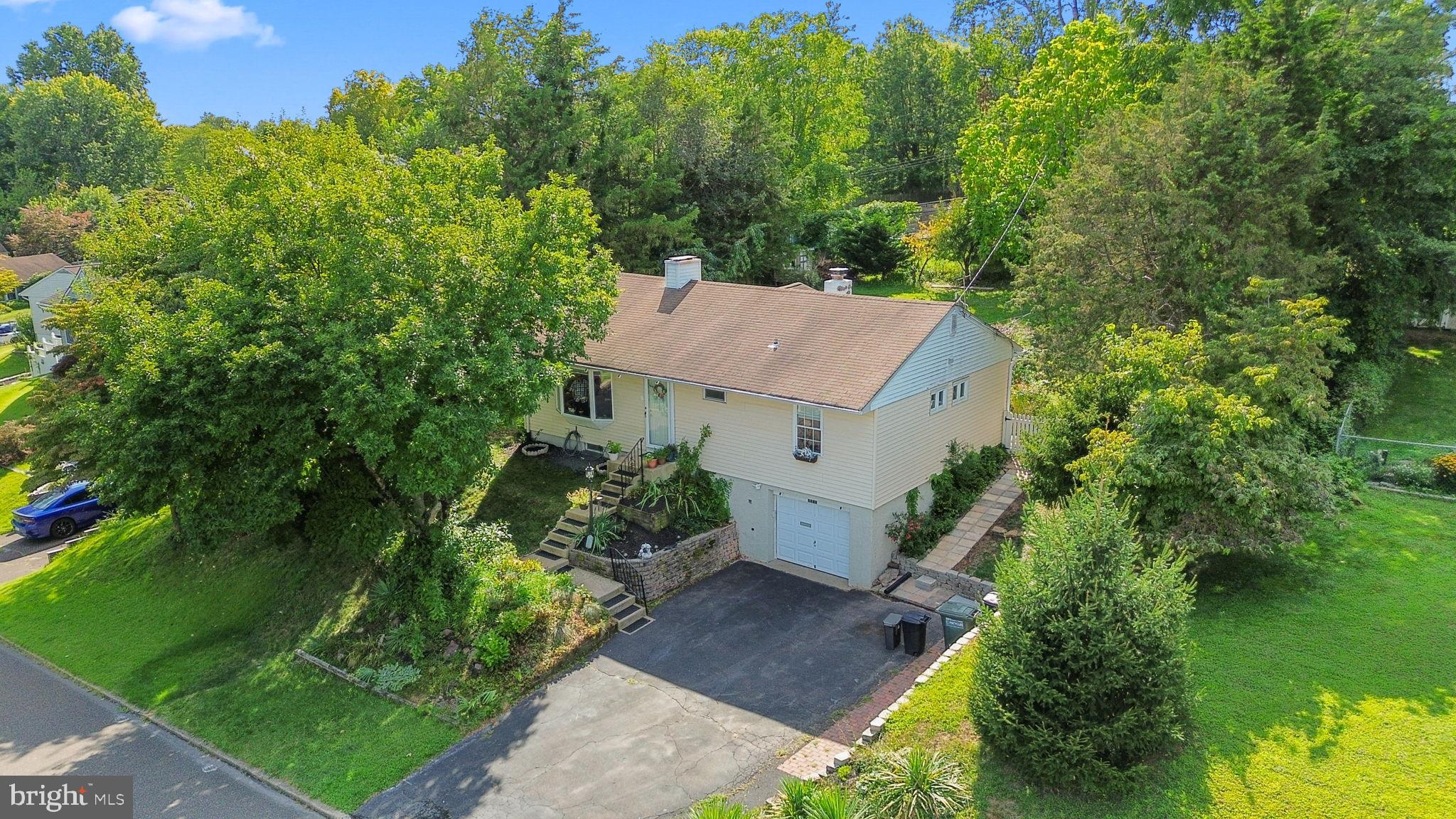 Welcome to this charming Willowpenn Rancher, ideally situated in the heart of Bucks County.
As you step inside, you are greeted by a spacious living room with refinished hardwood floors that flow into the dining area, complemented by a double-door coat closet for added storage. The kitchen is a true centerpiece—featuring vaulted ceilings, a cozy wood-burning fireplace, a large pantry, kitchen island, gas cooktop, crisp white cabinetry with pull-out drawers, durable mica stone countertops, and plumbing hookups for a water softener. Sliding glass doors open to the backyard, creating an airy, welcoming space for both everyday living and entertaining.
On the opposite side of the home, you’ll find the private bedroom wing with three generously sized rooms and an updated hallway bathroom. The primary bedroom includes two oversized closets and its own patio door leading outdoors—perfect for enjoying morning sunlight. All bedrooms feature gleaming hardwood floors, 8’ ceilings, ample closet space, and abundant natural light. The home also offers central AC with a built-in humidifier, an excellent feature for those managing allergies or asthma and anyone who enjoys fresher, cleaner air indoors.
The finished basement expands your living options with an extra-large open area accented by marble tile flooring—ideal for a family room, gym, home office, or guest suite. Unlike many homes in the area, the basement is completely dry and includes custom storage, giving you peace of mind for long-term use. A full bathroom with Jacuzzi tub, a dedicated laundry and utility area, and a private entrance through the garage make the space versatile for multigenerational living.
The garage is generously sized and features an insulated door, keeping temperatures more comfortable year-round whether you’re parking, storing belongings, or using it as a workshop. You’ll appreciate the one-car garage along with a driveway that provides parking for up to four vehicles.
Outside, a stone patio overlooks a lush backyard with a new $7,000+ shed, chicken coop, and a sturdy metal clothesline. The landscaping is designed to delight with flowers blooming in rotation from spring through winter. Surrounded by mature trees on a quiet, friendly block, this home offers a sense of calm while still being minutes from shopping centers, I-95, and an easy commute to Philadelphia and beyond. All of this comes with property taxes under $4,000 per year—a rare find in Bucks County.