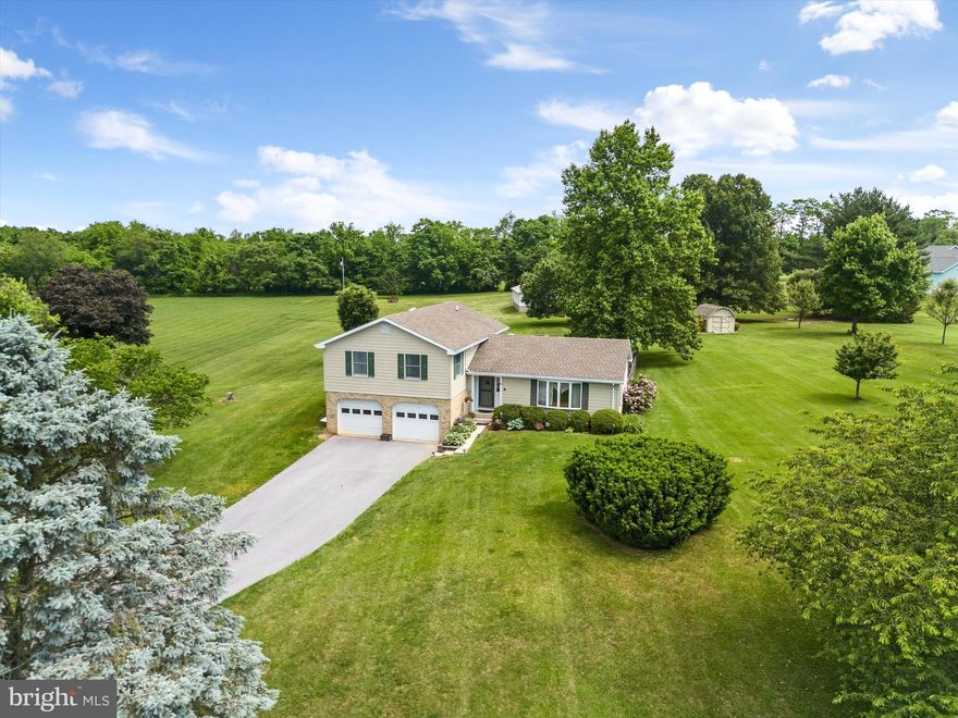 Don’t miss all four levels of this spacious 3 bed/2 bath split level home in Pembroke Grove, a quiet, established neighborhood with mature trees on the property.  The expansive 2.32 acres provides plenty of space for horses and barns, or simply take in the serene vistas from each window.
From the entry on the main level, the living room, formal dining room and eat-in kitchen are distinct yet connected for your enjoyment. Upstairs, you will find three exceptionally large bedrooms and two oversized baths. Descending a half-level is a spacious family room, laundry area, and the oversized garage. Down one more level is an unfinished basement. The backyard has a Trex patio and a concrete patio area that is ready for your hot tub or some lovely patio furniture. The fenced area at the rear of the house is convenient for your smaller furry friends. The lawn extends, level and luxurious, for gardening, horses, outbuildings, and beautiful views.