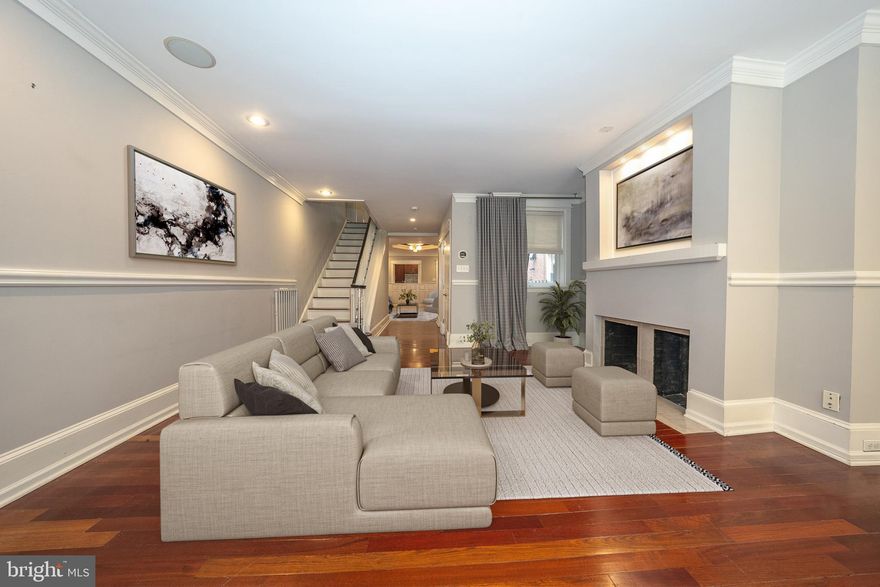 Situated in the heart of Society Hill, this distinguished three-story townhouse embodies refined urban living, seamlessly blending historic charm with contemporary luxury. With two-car garage parking, this residence offers a rare combination of space, style, and convenience
Step inside to high ceilings, recessed lighting, and rich Brazilian cherry wood floors that set a welcoming tone. The expansive living room flows seamlessly into a versatile dining or family area, where elegant architectural details enhance the home’s timeless appeal.
The kitchen is designed for both everyday living and entertaining, featuring top-tier Viking appliances, including a four-burner stove with a built-in grill. Just beyond, a private patio leads to the detached two-car garage—a true luxury in this sought-after neighborhood.
The second level is dedicated to the primary suite, filled with natural light. A wide hallway opens to an office, second level family room or extension to the already expansive primary suite.  French doors from this space lead to a newly rebuilt private deck, an ideal spot for morning coffee or evening gatherings. This floor also features a well-appointed laundry room with a sink and mini fridge, a discreet powder room, and a spacious bedroom with dual walk-in closets. The ensuite bath offers a spa-like retreat with a double vanity, oversized glass-enclosed shower, and elegant porcelain tile flooring.
The third level features three well-proportioned bedrooms and two full baths, offering flexibility for family, guests, or work-from-home needs. One bedroom enjoys the privacy of an ensuite bath, while another is enhanced by a charming (non-working) fireplace, creating a cozy atmosphere for a study or retreat. The third bedroom is spacious and bright, featuring double closets and sweeping southern views.
A fully finished lower level provides additional living space, abundant storage, and endless possibilities. A built-in surround sound system is wired throughout the home, ready to enhance any setting.
Perfectly positioned across from General George A. McCall School and just a short stroll to Washington Square and Pennsylvania Hospital, this exceptional residence offers the best of Society Hill living.

Some photos are virtually staged