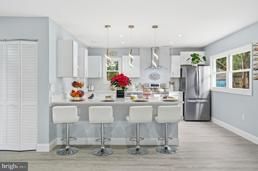 Seller is open to providing closing cost assistance with an acceptable offer! Fully renovated and move-in ready, this charming rancher offers modern style and effortless one-level living. Enjoy a nice cup of coffee on your covered porch and catch the sunrise. Step inside to find beautiful Luxury Vinyl Plank flooring and recessed lighting flowing throughout the home. The bright living room is perfect for relaxing or entertaining and opens seamlessly to the dining area and spacious, updated kitchen. The chef-inspired kitchen features abundant cabinetry, generous prep space, custom tile backsplash, quartz countertops, stainless steel appliances, a wine fridge, and a large island ideal for extra storage or quick meals. The spacious laundry room off the kitchen offers more storage for all your necessities. Down the hall, you'll find three bright, airy bedrooms and a beautifully updated full bathroom with custom tile surround tub/shower to relax in after a long day. Outside, the expansive yard provides plenty of space for gardening, play, or outdoor gatherings. With a long driveway that comfortably fits up to four cars, parking is never an issue. Major updates include a new roof, HVAC, and appliances—giving you peace of mind for years to come. Conveniently located near Emmorton Road, Philadelphia Road, and I-95, this home offers both comfort and accessibility.