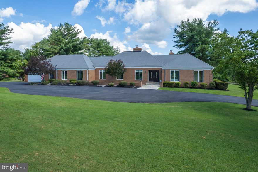 Serenity awaits at this gorgeous and bright single level brick residence in Glenelg Manor Estates situated on 4.83 pristine acres. The well-thought-out layout of the home has two primary suites. The wing of the home by the garage, houses one of the primary suites, and could easily be its own living quarters for an in-law or nanny suite. The home is adorned with soaring ceilings, an abundance of natural light and recessed lighting. Beautiful finishes throughout the home include oversized polished porcelain tile in the living room, dining room and sunroom, bamboo hardwood flooring in two bedrooms and the office, as well as maple hardwood flooring throughout the remaining rooms. The stunning step-down living room has vaulted ceilings and a massive, stacked stone wood burning fireplace with a mantle and hearth, and the connecting dining room is decorated with a mirrored wall. The generous chef's kitchen is fully equipped with an island, midnight blue granite countertops, ice blue backsplashes, under cabinet lighting, a Sub-Zero refrigerator and freezer, a Bosch double oven, and a wet bar with bubble-glass front cabinet doors, an ice maker and beverage refrigerator. Included in the sale are the chrome bar stools around the island as well as the matching midnight blue granite table and chrome chair set from the adjoining breakfast room. Both the breakfast room and adjoining family room have vaulted ceilings and ceiling fans, and the family room is also furnished with a stacked stone wood-burning fireplace. The sunroom pulls you into the picturesque setting with a wall of windows providing magnificent backyard views. The sunroom also has a skylight and a sliding glass door that leads to the large brick-floored screened-in porch also with a skylight, vaulted ceilings, and access to the rear patio. The bedroom wing of the home is comprised of three bedrooms, one full bath, and the main level primary suite featuring maple floors, a walk-in closet, and a large adjoining bathroom with granite tiled flooring, dual vanities, and a separate shower and soaking tub. Also in the bedroom wing is the laundry room which includes a full-size washer and dryer, cabinetry, and a water softener system. The office, dressed with bamboo flooring, is ideally located by the rear entry, affording the opportunity to have an in-home business with its own entrance, access to the back yard and patio, and next to the half bath with porcelain flooring and granite countertops. The media and bonus room are adorned with cinnamon stained maple hardwood floors, granite countertops, built-ins and space for another office, hobby/craft room, kids play area or a mudroom. They also provide access to the garage and the second-floor primary bedroom suite furnished with luxury vinyl plank flooring, ample closet space, skylights, a ceiling fan and remodeled full bath with porcelain floors, a walk-in shower, and vanity with granite countertops. The residence is equipped with Anderson Windows, an architectural shingle roof and is served by a private well and septic, multi-zoned central air conditioning, oil and electric heating systems. There is a separate shed for garden tools and equipment as well as an oversized two-car garage with workbenches, storage space, and rear garage door access for lawnmowers or bikes. The sprawling grounds provide ample space to build another garage, pool, sport court, firepit, putting green, or barn for animals. The HOA is community and event focused with plenty of seasonal activities planned throughout the year. The residence is adjacent to the private Glenelg Country School. Open House September 6th 1-3 PM. Please contact Marty with any questions.