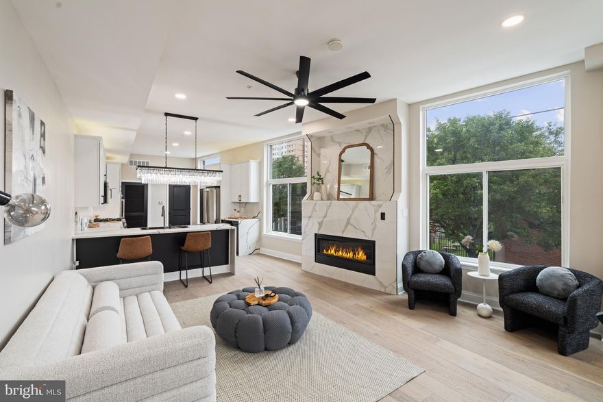 Welcome to The Estates at Queen Village, a rare opportunity to own a brand new custom luxury townhome in one of Philadelphia’s most sought-after and culturally rich neighborhoods. Surrounded by tree-lined streets, award-winning restaurants, artisan cafés, and historic architecture, this 3,600+ sq. ft. corner masterpiece delivers the ultimate blend of city living, modern design, and suburban-style space — all with the added benefit of a full 10-year tax abatement. Perfectly positioned on a sun-drenched corner lot, this end-unit home is wrapped in light and elegance, offering unmatched privacy, elevated finishes, and the charm of a quiet block just steps from premier amenities. Designed with a striking white brick façade, the exterior honors traditional Philadelphia character while introducing refined, modern craftsmanship throughout. Inside, this 4-bedroom, 4.5-bath residence showcases thoughtful architectural detail, premium materials, and custom designer touches at every turn. The one-car garage features epoxy-coated floors, an electric vehicle charger, and double garage doors for enhanced privacy and security—a rare and valuable feature for city living. A tailored mudroom with built-in storage and direct garage access provides a seamless and practical entry point. The finished lower level offers radiant heated floors, a sleek wet bar with wine fridge, a beautifully tiled spa-style bathroom, and a versatile bedroom ideal for guests, an office, or in-home gym. A convenient first laundry area completes the lower level. A floating staircase with glass and aluminum railings leads to the open-concept main floor, where soaring 12-foot ceilings, wide-plank white oak floors, and expansive windows bring in abundant natural light. The formal living area is anchored by a dramatic gas fireplace and flows effortlessly into the dining space and chef's kitchen. Outfitted with custom European cabinetry, a full suite of Viking appliances, and a bold waterfall-edge quartz island, the kitchen is as functional as it is striking. A chic powder room with a smart toilet and LED mirror adds a layer of contemporary polish. The third level is a dedicated sanctuary for the primary suite, featuring a custom accent wall, two large walk-in closets, and a spa-like bath complete with radiant heated floors, a freestanding soaking tub, frameless glass rain shower, floating double vanities, LED mirrors, and full-height designer tilework. The fourth level offers two additional bedrooms, including an en-suite with a private balcony, plus a third full bathroom and second laundry room for added convenience. A stylish wet bar creates the perfect lead-in to the crown jewel of the home: a private rooftop deck finished with fiberglass tile flooring, custom lighting, and unobstructed panoramic views of the Philadelphia skyline. Whether entertaining under the stars or enjoying quiet mornings above the city, this space delivers a true urban retreat. With high-efficiency mechanicals, top-tier fixtures, and meticulous design, 246 Montrose Street redefines modern luxury in a historic setting. This one-of-a-kind corner residence offers the rare opportunity to own new construction of the highest quality in the heart of Queen Village. Your luxury urban sanctuary awaits.