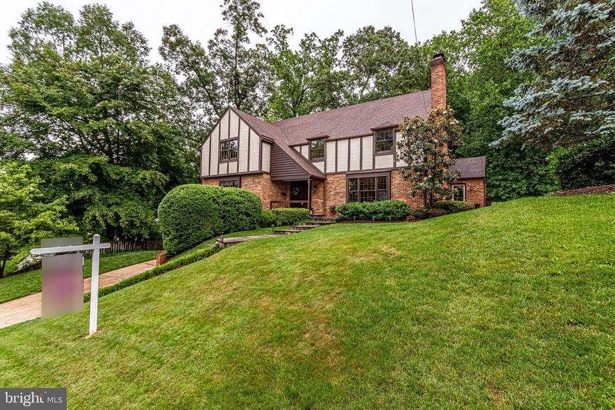 Fabulous Tudor in Chain Bridge Forest with large, private backyard  backing to woods.  This home has 5 bedrooms 2 full baths and 2 half baths with laundry on the upper level. The main level is perfect for entertaining with a large updated kitchen including double wall ovens, subzero fridge, a large center island, tons of cabinet storage and space for eating. The kitchen opens up to the spacious rear deck as well as to the side grilling deck. The main level also boasts a formal dining room and living room, a family room adjacent to the kitchen a large powder room and a bright study/library.  The upper level has 4 very spacious bedrooms, a hall bath with doubly vanity, and a luxurious owner's suite. The lower level is perfect for gaming, exercising, TV watching and has a bar area with rough in plumbing and an additional half bath. French doors walk out to the lower level patio and lawn area. A 2-car garage  and large driveway provide ample parking. This home is perfect for entertaining a large crowd. Only 1 stop light to DC, close to Tysons, Ballston/Clarendon and in the Yorktown High School pyramid.