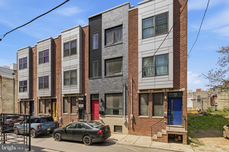 Welcome to 1448 N Myrtlewood St, a stunning 4-bedroom, 3-bathroom home located on one of the most desirable blocks in vibrant Brewerytown. Nestled on the 1400 block—a quiet stretch lined almost entirely with new construction single-family homes—this property stands out with style, space, and thoughtful upgrades, plus excellent FREE street parking. Step inside to a beautifully designed open-concept layout, featuring Calcutta quartz countertops, a sleek waterfall peninsula, custom backsplash, and stainless steel appliances. The elegant, modern touches continue with floating vanities in the bathrooms and rich hardwood flooring throughout. The finished basement adds additional living space, perfect for a home office, media room, or guest suite. Retreat to the master suite, where you’ll find a striking tray ceiling, a built-in wine fridge, and direct access to the private roof deck, offering expansive city views. Additional features include dual-zone HVAC for year-round comfort and smart climate control. This home also comes fully equipped with upgrades rarely found at this price point, including a mounted 70-inch TV with an integrated sound bar and subwoofer, and CB2 kitchen furniture, all included for your convenience. Located just steps from 29th & Girard, you’ll enjoy easy access to public transportation, major highways, and some of Brewerytown’s most beloved restaurants, including Green Eggs Café, Rybrew, and Spot Gourmet Burgers. With high-end finishes, smart upgrades, and unbeatable location, 1448 N Myrtlewood St is the perfect place to call home.