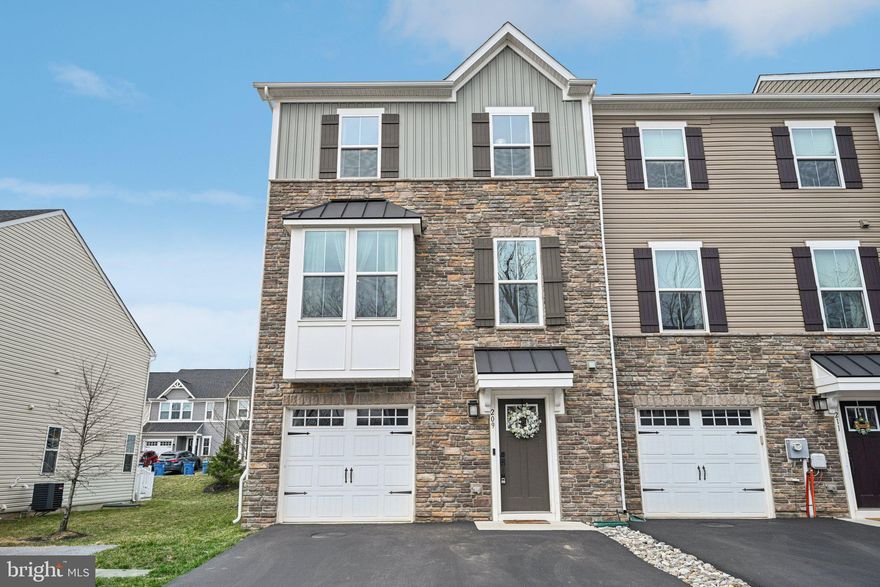 Welcome to 209 Hibiscus Way — a stunning end-unit townhome in the desirable Downingtown Walk community that perfectly balances style, comfort, and convenience.  This three-level home boasts 2,188 square feet of living space, featuring three spacious bedrooms and two and a half bathrooms.  From the moment you walk in, you’ll be drawn to the thoughtful upgrades and beautiful finishing touches throughout. The open-concept main level impresses with rich flooring and fresh, modern design. At the heart of the home is the kitchen, featuring a spacious center island, sleek granite countertops, classic white cabinetry, stainless steel appliances, and a mix of recessed and pendant lighting for a warm, inviting glow. The kitchen flows effortlessly into the bright and airy living and dining spaces, creating an ideal layout for entertaining. A charming built-in bench seat with storage in the living room adds both functionality and character. Step outside to the expansive elevated deck — the perfect spot for relaxing or hosting gatherings. Upstairs, unwind in the luxurious owner’s suite, where a tray ceiling adds elegance and a walk-in closet with custom shelving provides ample storage. The en suite bath offers a dual vanity and a beautiful glass-enclosed shower for a spa-like retreat. Two additional spacious bedrooms, a stylish hall bath, and a convenient second-floor laundry room complete this level. The fully finished lower level adds even more living space, complete with a cozy family room, a powder room, and interior access to the garage, which features custom shelving for added storage. As a unique bonus, the living room closet offers the potential to be converted into a fourth bathroom — the plumbing and electrical are already in place, thanks to an original builder oversight. Enjoy low maintenance living with easy access to Downingtown Boro’s vibrant shopping, dining, and entertainment options. Don’t miss your chance to make 209 Hibiscus Way your new home — schedule your showing today!