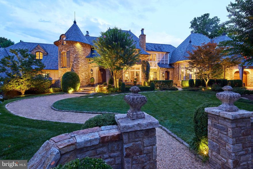 Inspired by the sublime country houses of the English Cotswolds and French countryside, this extraordinary Langley Farms estate residence was custom designed for discerning owners with an eye for modern luxury.   The exteriors were hand-crafted from 300 tons of foundational field stone primarily sourced from century old structures along the Oregon Trail. The 16,000 square foot, 7 bedroom residence constructed by Galileo Group sits on nearly an acre and a half with manicured grounds by celebrated landscape architect, Charles Owens. Garage parking is available at each end of the estate including a pea gravel motor court. Inspiring interiors incorporate old world accents such as barn wood beams, antique Dalle du Bourgogne limestone, reclaimed Provencal terra cotta, a circa 1900 floor to ceiling hand carved fireplace and antique iron wall grilles. Contemporary and traditional furnishings combined with a timeless neutral color palate create a freshness that highlights the perfect layout and flow across three floors. The main level embraces the romantic primary suite with a private office and two oversized walk-in closets, a tucked away computer work station within the kitchen and great room, a dramatic double height dining room, and a two story library with a spiral staircase.  The lower lower level includes a generous bedroom suite and kitchenette, plus a versatile sports court with antique oak suspended spring floors designed to double as an entertaining pavilion. Additional highlights include a second floor media and game room, a sunlit lower level living room, wine cellar, and generous storage. Often the unseen is as important as the visible, and this home includes a geothermal system.