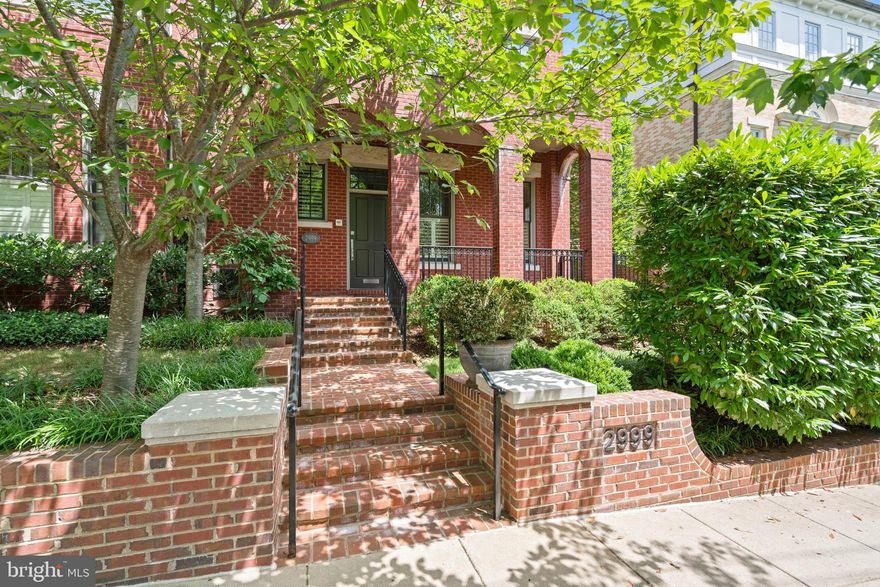 This elegant three-story custom semi-detached townhouse is desirably located in Alban Row. The house is discreetly located off the street and offers impeccable privacy from front hedges, a front yard, and layered landscaping. The charming front porch and iron railings enhance the attractive brick facade. This stunning residence features hardwood floors, lovely moldings, and an elevator servicing all floors. The main level is flooded with sunlight from oversized windows, including an attractive transom over the front door. The entry foyer boasts a soaring two-story ceiling with sightline views to the rear of the home. It transitions seamlessly into the living room, equipped with custom plantation shutters, and then to the sophisticated dining room with built-in cabinetry. The gourmet eat-in kitchen is well-appointed with a large center island with a breakfast bar, a Viking six-burner range, and ample cabinet storage space. It opens to the family room/breakfast area, which also features plantation shutters and access to the rear terrace through French doors. The fully enclosed rear terrace, surrounded by a brick wall, offers immense privacy. It is perfect for entertaining, with a seamless flow from indoors to outdoors and a flagstone table-space terrace. Additionally, the main level offers a coat closet and a powder room for added convenience. The second level features two bedrooms and two bathrooms, including the luxurious primary suite. The primary bedroom is generous and well-appointed with two walk-in closets, a Juliet balcony, and an en-suite bathroom featuring dual vanities, a frameless glass shower with a bench, and a large Jacuzzi tub. The second bedroom on this floor is also spacious, with its own bathroom and a large closet. The third floor provides two additional bedrooms, a den, a hall bathroom, a storage closet, and a fully equipped laundry room with cabinetry, a folding station, and a utility sink. The lower level offers additional storage and access to the oversized two-car garage. This incredible offering is within close walking distance to neighborhood favorite schools, restaurants, parks, and Washington National Cathedral.