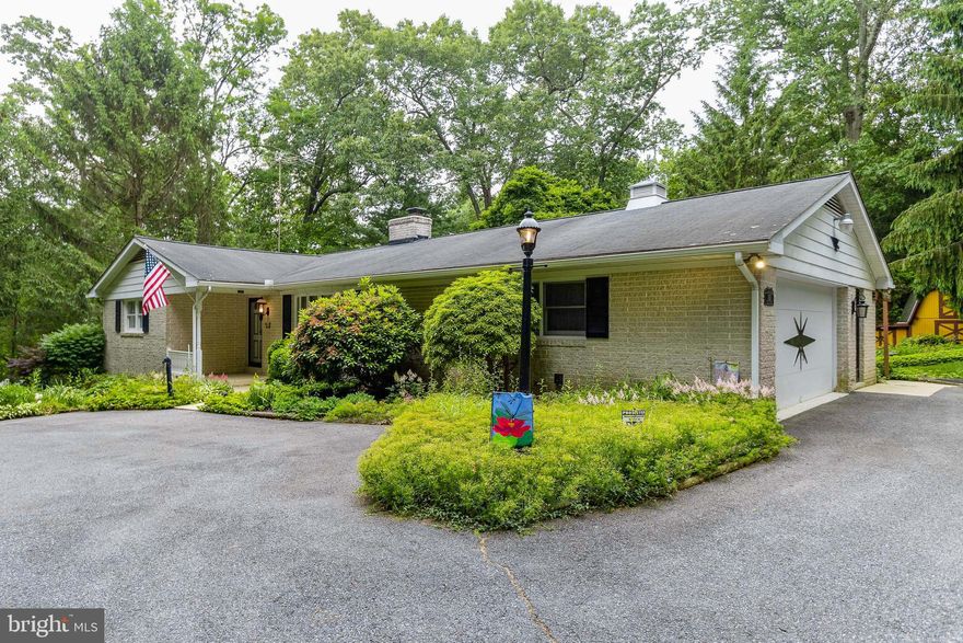 Large attractive rancher set back from the road in great location.  Beautiful grounds. you will be amazed at the quality and spaciousness of this home.  Well built, but in need of some updates.  Sold "as is".  Drive back to a 2 car garage and additional parking for at least 6+ cars.  Enter the side door to a mud/laundry room.  Kitchen can easily be expanded and updated. Living room has a wonderful brick wood burning fireplace.  The bay window brings in plenty of light.  The primary bedroom has 2 large closets with wonderful built-ins.  There is a primary bathroom with walk-in shower.  This level also has a second bedroom and the main bath.  Down to the lower level of another 1500 sq feet that is mainly finished.  The extra large family room has another beautiful fireplace - this one with a Kodiak wood stove insert.  The third bedroom and third full bath are down here.  There is also a large bonus room which can be anything you want or need  wander outside to the patios in the back and you will feel like you are in a secluded garden.  Though not updated, this home has been wonderfully maintained.    Roof replaced in 1995.  AC replaced in 2000.  Sold "as is"  Home warranty provided.