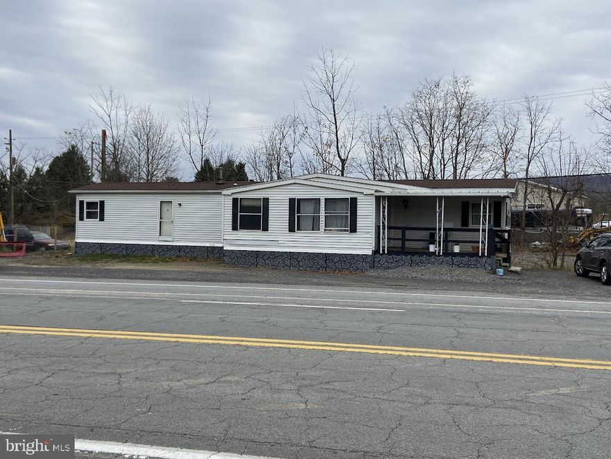 1.11 Acre commercial lot with 2,082 SF heated garage w/rest room and 2 bedroom mobile home. Both the garage and residence are currently leased but only on month-to-month. Property also licensed for an Auto Salvage yard.