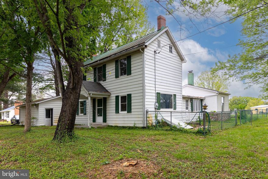 This charming Colonial-style home, built in 1890, offers a blend of classic character and modern convenience. With 1,672 sq. ft. of living space, the interior features solid hardwood and vinyl flooring, creating a warm and inviting atmosphere. The eat-in kitchen is equipped with an electric oven/range and a refrigerator. Enjoy the traditional floor plan with built-ins, an entry-level bedroom, and a bathroom featuring a tub and shower. The exterior boasts aluminum siding on a level on a .55-acre lot, providing ample room for outdoor activities. The property includes a detached garage with side entry and a gravel driveway. Enjoy scenic views of the garden, lawn, and surrounding mountains from your front and fenced rear yard.  Located in a peaceful rural setting, this home is not part of a development, offering privacy and tranquility. The community is known for its rural atmosphere, with nearby parks and recreational areas for outdoor enjoyment. Local schools are within easy reach, providing quality education options. Public services are readily available, ensuring convenience for residents. This property presents a unique opportunity to own a piece of history while enjoying the benefits of a vibrant community. Don't miss your chance to make this charming residence your own!
