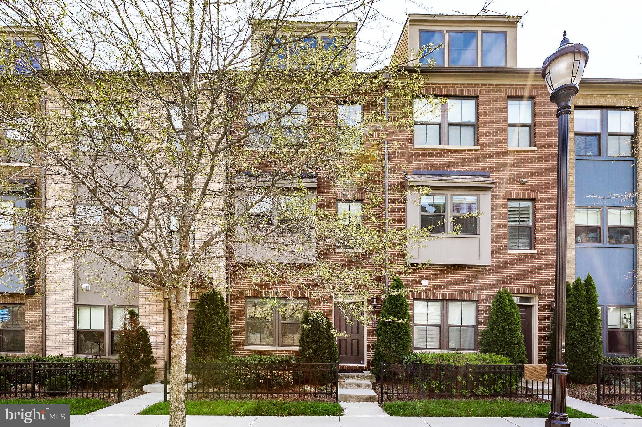 Welcome to Riverdale Park Station! This 4-level townhome with a 1-car garage was built in 2017 and beautifully maintained by its original owners. Inside, enjoy wood floors, high ceilings, and a bright, open layout.The main level features a gourmet kitchen with quartz counters, double wall oven, and a large island—perfect for cooking and entertaining. The living room opens to a balcony, and the dining area has elegant trim work. A flexible first-floor space can be used as an office, guest room, or family room. Upstairs, you’ll find two spacious bedrooms, including a primary suite with a glass shower and bench. The top-floor loft makes a great office or extra bedroom and leads to a private rooftop terrace—ideal for relaxing or hosting friends.Just steps from the Trolley Trail, Village Green, and farmers market, and close to Whole Foods, Starbucks, dining, and gyms. Easy commute with free shuttle to the College Park and Metro stations.
Comfort, convenience, and community—welcome home!