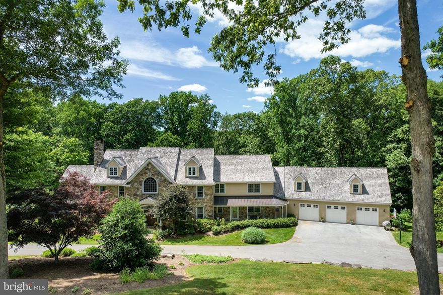 Nestled in a beautiful cul-de-sac of Chester Springs, 6 Douglass Lane is located in the highly desirable Douglass Lane subdivision—consisting of 9 custom Birchrun Builders homes. This elegant custom-built traditional farmhouse has 7600 sq. ft. and is located on 5.5 acres. Seclusion and privacy underscore this 5-bed, 6.3-bath, and 3-1/2 car garage home. Enter through a spectacular two-story foyer with an arched clerestory window, grand floating staircase, wainscoting, and beautiful hardwood floors with walnut inlay borders. To your left is a formal living room with a gas fireplace and to your right a formal dining room with wainscoting and beautiful crown molding. The front of the house has two additional side entrances that lead to an open floor plan with a gourmet kitchen, breakfast room, cafe, great room, formal office, music room, mudroom, screened-in porch with cedar decking, and two half-baths. The gourmet kitchen includes granite countertops, built-in Sub-Zero refrigerator, Thermador commercial cooktop oven, custom-made hood, double sink, Bosch dishwasher, cherry "Quality" Cabinets with a built-in pantry and hutch, a second oven built into the kitchen island. Two skylights provide plenty of natural light and the Italian tile flooring gives the kitchen a warm feel. Adjacent to the kitchen is a fully equipped "Quality" Cabinet butler’s pantry, along with a fourth pantry space. A delightful café with granite countertops, a hand-hammered copper sink, built-in Bosch microwave, dishwasher, and beverage center is right off the kitchen, and leads out to a weather-resistant, maintenance-free, Trex Composite Deck with cedar landing and steps—all designed for great entertaining! Cathedral ceilings, skylights, a full-stone masonry wood-burning fireplace, and a "Quality" Cabinets built-in entertainment center with a wet bar, cast-iron sink and granite counter define a fabulous step-down great room. Walk through a cozy music room and enter a relaxing screened-in porch with a decorative batten board ceiling. The formal office is a distinguished workspace that is freshly painted with molding, windowsills,  crown molding and a private patio. A spacious mudroom with custom cabinets, sink area, double-stacked washer and dryer, along with two additional powder rooms complete the main level. Two separate stairways access the second floor landing for a very flowing floor plan. The upper level includes an expansive master bedroom with an over-sized en-suite, a large sun-filled sitting room, a bonus room, plus four additional bedrooms (all with their own unique en-suite.) The master en-suite is exceptionally large with two full baths, a huge walk-in shower, two walk-in closets, and a luxurious jetted tub. Also on the upper level is a laundry room with washer and dryer, granite countertops with a fantastic cast iron Kohler sink, plenty of cabinet space, and a huge walk-in closet. The bonus room, which can double for a second office, playroom, studio space, guest room, or in-law suite, adds an enormous amount of flexibility to the overall floor plan. The lower level of the home is the ultimate entertainment center with a unique custom-made Kountry Kraft Cabinetry bar with black Galaxy Granite counter- tops. In addition to the bar are a kitchenette and wine cellar. The wine cellar has exposed beams, built-in wine racks, and flagstone sills with 8” thick building stone wainscoting. Bead board and cedar wainscoting punctuate the perimeter of the lower level, as well as the half baths, which gives the entire space a unique lodge-like feeling. A stunning Coffered Ceiling, magnificent wood-burning fireplace, and access to a very private flagstone patio highlight the lower-level great room. In addition to a gaming spaces and a dining area there is another full bath with a large walk-in steam shower.