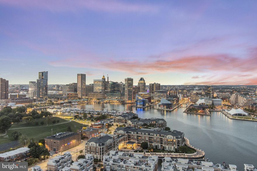 Discover the epitome of urban luxury in this architecturally exquisite two bedroom, two and one half bathroom penthouse condo. Located in the heart of Baltimore, this residence offers unparalleled views. To the north, gaze upon the captivating downtown skyline and the bustling of Harbor East. To the south, you’ll be enchanted by the majestic Key Bridge  the iconic Domino Sugar sign and the view of the  Harbor View Marina. Step inside to find a chef inspired kitchen that is truly a masterpiece. Custom book-matched cabinets add an elegant touch, making entertaining a joy. The primary suite is a haven of relaxation with a soaking tub and an adjacent natural gas fireplace, a domed tile shower, creating a tranquil escape with stunning city vistas. This penthouse doesn’t stop at the interior; it seamlessly connects with the outdoors. Multiple patios beckon you to savor the fresh air, with both northern and southern exposures offering different perspectives of the vibrant city below. When it comes to comfort, you’ll appreciate heated floors in the primary bath that keep you cozy during those cooler seasons. The building itself is a paradise of amenities. Take a dip in the indoor pool or break a sweat in the state-of-the-art fitness center. Host memorable gatherings in the entertainment spaces. Bask in the sun at the outdoor pool. Valet Parking is available for your guests. Safety and service is paramount with 24-hour concierge and secure building access.