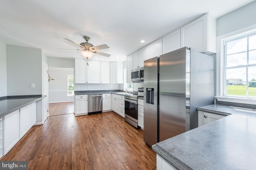 Enter into your large sun-filled foyer with beautifully refinished hardwood flooring that seamlessly flows throughout the first floor.  Enjoy an oversized kitchen with tons of prep space, custom white shaker cabinetry, new countertops and new stainless steel appliances.  Off the kitchen is a formal dining area with two sets of double doors that lead two your front deck and rear deck.  On the main level you will find a large living room and a large family room with an electric fireplace.  Also on the first floor you will find a bedroom and a conveniently located half bathroom. Upstairs you will find two generously sized bedrooms, a full updated bathroom and a huge master suite.  The master suite features a separate deck overlooking the landscape, walk in closet, and a full bathroom with double vanity, shower, and jacuzzi .  The outside space is to be desired with two massive decks and over 3 acres of your own private and very peaceful grounds.  This house also features a two car garage and plenty of driveway parking space as well as an unfinished basement with tons of storage space.  This house has been pristinely maintained and features all new paint and flooring throughout.  House is vacant and easy to show so schedule your showing today!