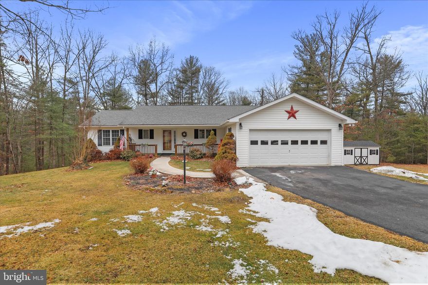 There’s a certain kind of property people move to West Virginia hoping to find — space around you, quiet when you want it, and a home that feels solid the moment you step inside. Located in the established Hickory Corner Subdivision, this home sits on a double lot totaling just over 4.33 acres, offering room to spread out while remaining within convenient reach of Winchester, Virginia, Northern Virginia, and the Eastern Panhandle of West Virginia. With more than 2,500 finished square feet, the layout is practical, comfortable, and designed for everyday living rather than passing trends. The main level centers around an open living space with hardwood floors and a propane fireplace that anchors the room and creates a warm, welcoming atmosphere. The kitchen flows naturally into the living and dining areas, making the space equally suited for quiet evenings at home or gatherings with family and friends. Three bedrooms and two full bathrooms are located on the main level, along with a laundry room thoughtfully positioned where daily life happens. The primary suite offers a private retreat featuring a jacuzzi tub and double vanity designed for comfort and convenience. The finished basement adds meaningful flexibility, offering a large family room, a dinette with a secondary kitchen area, an additional bedroom, and a full bathroom — ideal for guests, extended family, or separate living space. An additional 576 square feet of unfinished area provides excellent storage or the opportunity for future expansion. Outside, the property continues to impress with a paved driveway leading to a two-car attached garage, along with a rear deck and welcoming front porch that invite you to slow down and enjoy the surroundings. The double-lot configuration is a true value contributor, providing added privacy, usable land, and long-term flexibility that is increasingly difficult to find in today’s market. Conveniently positioned for commuters and weekend travelers alike, the home offers easy access to Winchester and Northern Virginia while allowing you to enjoy the pace and setting that make Hampshire County such a desirable place to live. If you’ve been waiting for a home that feels genuine the moment you arrive — not staged, not overdone, just right — this is your opportunity. Schedule your private showing and experience it for yourself.