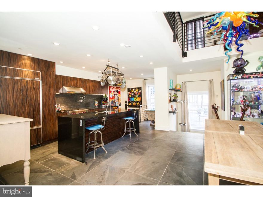 Immense character lies in this historic, one-of-a-kind, 3-4 bedroom, 2.5 bath home complete with 2775sqft of living space. It begins with a vestibule entry with large window, slate floor, recessed lighting and coat closet. Step up into kitchen/dining area with soaring ceilings, slate floor, powder room, storage area under stairwell and door leading to patio and breezeway. Gorgeous chef's kitchen with Wolf range and oven, subzero refrigerator, custom tiger wood cabinets, slate tile backsplash and granite counter tops with bar island. Alcove with window and a spiral staircase leading to lower level wine cellar with exposed brick, archways, hardwood floor and separate workout room. On the second floor you'll find the large living room spanning the entire width of the house (23 feet) with wide plank hardwood floors, 4 windows facing Arch street, exposed brick, track lighting and door to balcony. The third floor offers a hallway laundry closet, two bedrooms and an elegant slate tile bathroom with soaking tub and glass wall. First bedroom is large with two exposures, three windows and beautiful hardwood floors. Front bedroom has two windows, a wall of closets and hardwood floors. Floating staircase leads to master bedroom suite with vaulted ceilings, two windows, wall of closets and dressing room with a window. Magazine quality bathroom with walk in shower stall with amazing multi-head shower, glass tile, double vanity, whirl pool tub and state of the art lighting. Spiral staircase leads to deck facing Ben Franklin Bridge. This property also features an amazing theatre quality TV and audio system individualized in every room! Quiet area of Old City yet steps from all the action. Close to 95, Ben Franklin Bridge, restaurants, cafes, galleries and all the historic land marks.