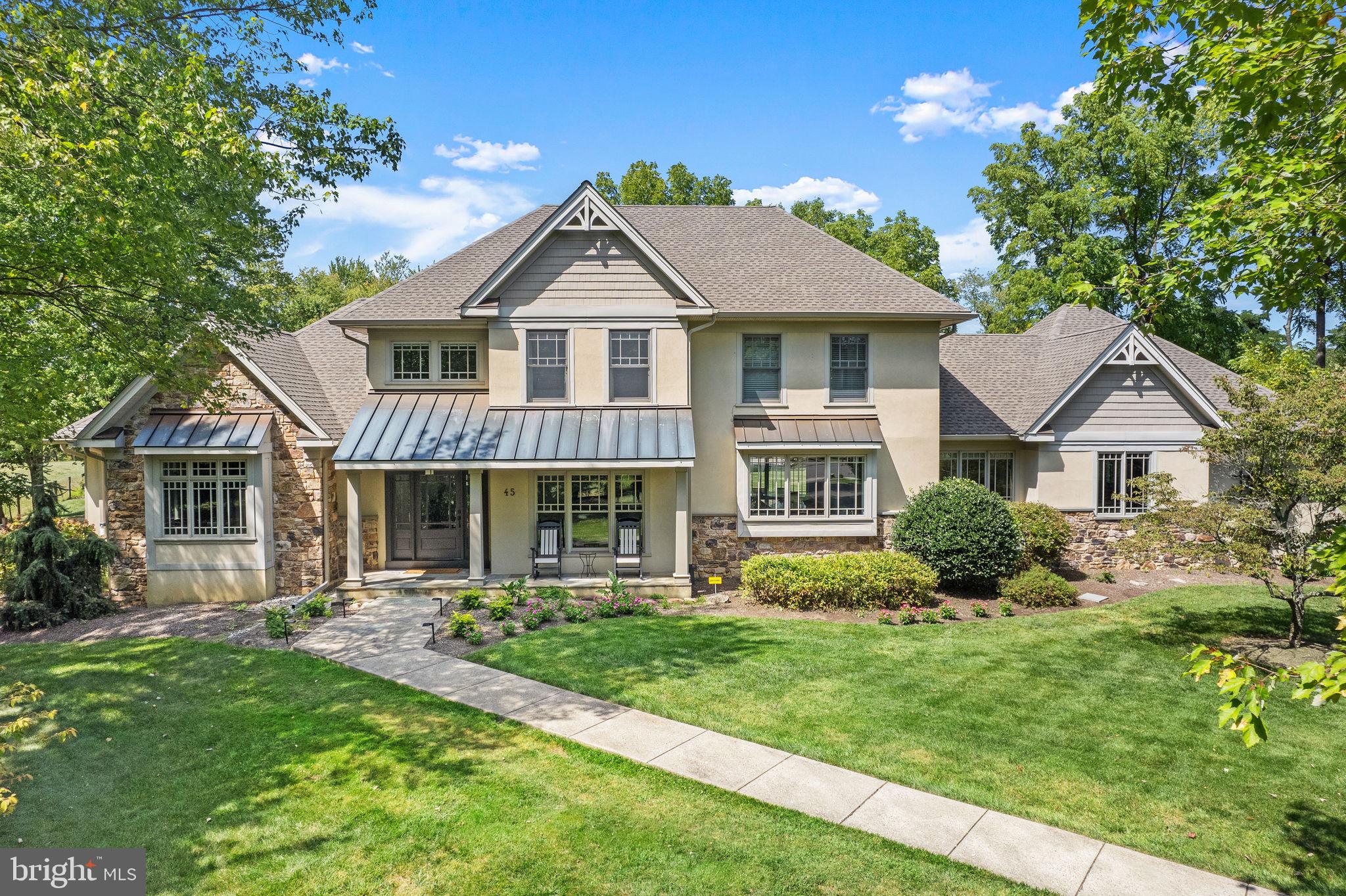 This beautifully inspired 4 bed, 3 full and 2 half bath home is truly stunning and shows like a designer model with thoughtful details blending seamlessly throughout each room. This custom home is rich in eye-catching millwork, moldings and architectural elements with one of the most striking features being the unique custom windows that add a level of design and style that elevate and impress. Offering an open floor plan while taking advantage of the abundance of natural light, the easy flow layout and generously sized rooms provide the perfect opportunity for entertaining and hosting family gatherings. The wide and airy foyer extends to the rear of the house, with built-in seating and hardwood floors that grace the majority of the main level including the formal living room adorned with a beautiful, coffered ceiling and wall of windows with picturesque views of the lush green front landscape. A double-paned glass door provides entry into the private front Study with two walls of craftsman styled built-in shelving and desk. The first floor Primary Suite offers convenience and luxury with 2 walk-in closets, soothing neutral colors and full bath with travertine radiant heated floors, soaking tub, 2 separate vanity areas and frameless shower. A sunken Gathering Room with gas fireplace, custom bookshelves and cabinetry for storage is at the heart of the home. Continuing the desirable flow, the neighboring breakfast area boasts a custom built-in buffet that is open to the Gourmet Kitchen. This is a gorgeous space featuring a striking marble-topped eat-in island, farmhouse sink, high-end appliances, stunning soapstone counters and tile backsplash. There is a corner nook off the kitchen offering a handy secondary office space with neutral cabinetry and desk. Completing this level is a mud room with bench/drop off zone with access to the 3-car garage plus a laundry room with sink and storage. On the upper level is a spacious Junior Suite with bonus room and huge walk-in closet, 2 bedrooms sharing a roomy, sunlit Jack and Jill bath with water closet and a walk-up attic perfect for storage. A finished lower level offers extended living space with entertainment game room, sitting area, half bath and large storage room with convenient garage access. The quiet cul-de-sac location provides the ultimate privacy with a mature tree-lined border and backing to farmland. Additional amenities include NEW gutters, NEW roof, NEW water softener and filtration system, NEW stairway runner, surge protectors, whole house generator, fresh carpet and paint. All of this in the award-winning Council Rock School District with convenience to the nearby towns of Newtown and Washington Crossing and the I-295 corridor for commuting. Truly one of a kind!