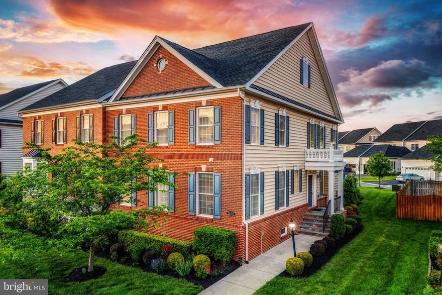 Welcome to 23412 Longollen Woods Terrace—an elegant end-unit villa-style townhome offering nearly 4,000 square feet of refined living in one of Ashburn’s most desirable communities. From the charming covered side-entry porch and Trex deck, lawn irrigation system, to the 2-car rear-load garage, this home blends low-maintenance ease with high-impact style. Inside, you’ll find soaring two-story ceilings in the family room, hardwood floors throughout the main level, and custom lighting that adds warmth and sophistication. The open-concept kitchen is a standout, featuring rich espresso cabinetry, upgraded countertops, a large center island, stainless steel appliances, cooktop with wall oven and microwave, and a cozy eat-in nook. The adjacent family room with gas fireplace creates the perfect hub for entertaining or unwinding. A formal dining room adds versatility, and a powder room rounds out the main level. The main-level primary suite is a true retreat with a walk-in closet and spa-inspired en-suite bath. Upstairs are three spacious bedrooms and a full hall bath, while the finished lower level offers a massive rec room, oversized den, and full bath—all with high ceilings that make the space feel bright and open. This home is part of an amenity-rich HOA that includes three pools, two fitness centers with classes, tennis courts, walking trails, tot lots, and even lawn care for both front and back yards. Enjoy quick access to Loudoun County Parkway, the Toll Road, Metro, Dulles Airport, Loudoun One, Brambleton, and top-rated Loudoun County schools—all within walking distance. This is low-maintenance luxury living at its finest—don’t miss it!