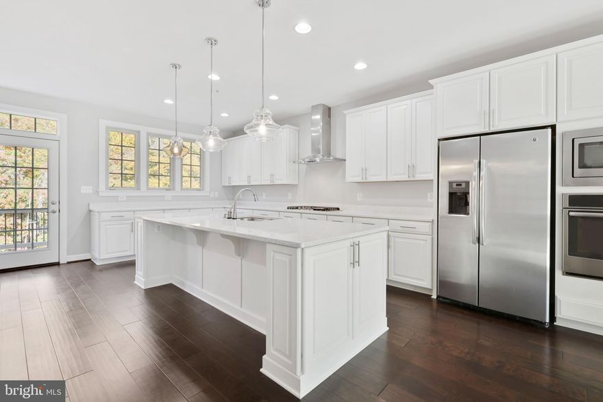 Welcome to this beautiful townhouse by NV Homes in the coveted Parkside community! Enjoy three bedrooms, 2.5 bathrooms, a huge gourmet kitchen, lower level rec room, two car garage, private view, and top of the line finishes! As you pull into the driveway, you have space for two cars, plus an attached two car garage with storage closet. Walking into the first floor, enjoy a large rec room with additional storage closet and walkout to the backyard. Upstairs, you will be amazed by the gorgeous gourmet kitchen! It boasts hardwood floors, tons of cabinet and counter space, stainless steel appliances and gas range, huge island, and large dining area. Step outside for some morning coffee or grill some dinner and dine outside on the balcony with private, wooded view. The top level features two secondary bedrooms, full hall bathroom and laundry room. Don't forget the primary oasis, with walk-in closet, tray ceiling, and beautiful bathroom with double sinks and massive shower with two shower heads. All of this is complimented by the community clubhouse, outdoor pool, playground, and more! As if this weren't enough, you are in close proximity to Fort Meade, grocery store/shopping, I-295 and I-95 for easy commuting to Baltimore and DC! Be sure to tour this home as soon as you can before it's gone!