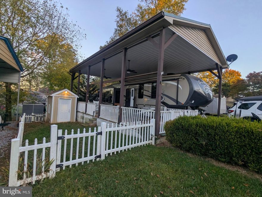 Discover this remarkable 2015 Forest River Sandpiper fifth wheel, an expansive 37-foot RV that boasts 5 spacious slides, offering ample living and storage space. This property includes not only the camper but also a welcoming pavilion and a sturdy deck, all set within a secure, fenced area. 

The outdoor space is perfect for families, featuring a fenced yard where children can play safely, and there's plenty of room for your beloved pets to roam and enjoy. The shed on the property is equipped with electric power, providing added convenience for storage or hobbies.

The pavilion features an enclosed ceiling complete with ceiling fans, making it an ideal spot for relaxing or entertaining, regardless of the weather. Additionally, the porch is designed with sunshades that can be adjusted to block out sunlight or provide extra privacy whenever needed.

Don’t miss out on this fantastic opportunity! Schedule your appointment today to explore this stunning RV and its excellent amenities.

This is a gated community, so you need to enter at the guard shack. Entry is not permitted without ID per the office rules. Bring IDs to the office or guard shack for visitor pass. THIS IS A SEASONAL CAMPGROUND! OPEN FROM APRIL 1 TO NOVEMBER 1. This lot is conveniently located for walking to the swimming pools, restaurant/lounge, mini golf, youth center, playgrounds and more. Large lot to enjoy time with your family & friends. River Bend is a privately owned 400 acres recreational- vehicle camp resort with seasonal activities for members, families and guests. Less than a 2-hour drive from the Washington and Baltimore metro area. Open with utilities from April 1 to November 1. Lot owners have access to their property the entire year. *** Members Enjoy *** * Amazing views and wildlife, Potomac River access, Trails, Swimming pools, Mini-Golf, Youth center, Tennis and basketball courts, laundry facilities, convenience store, deli and lounge. *Bath houses throughout the park, boat ramp, bar and grill and even a church located on the grounds. River Bend also hosts numerous activities such as 4th of July fireworks, small carnival, bonfires, poker runs, horseshoe tournaments, car show, Halloween Trick or Treat and so much more. The river is deep water for swimming, tubing and water skiing. CAN NOT LIVE HERE YEAR-ROUND.