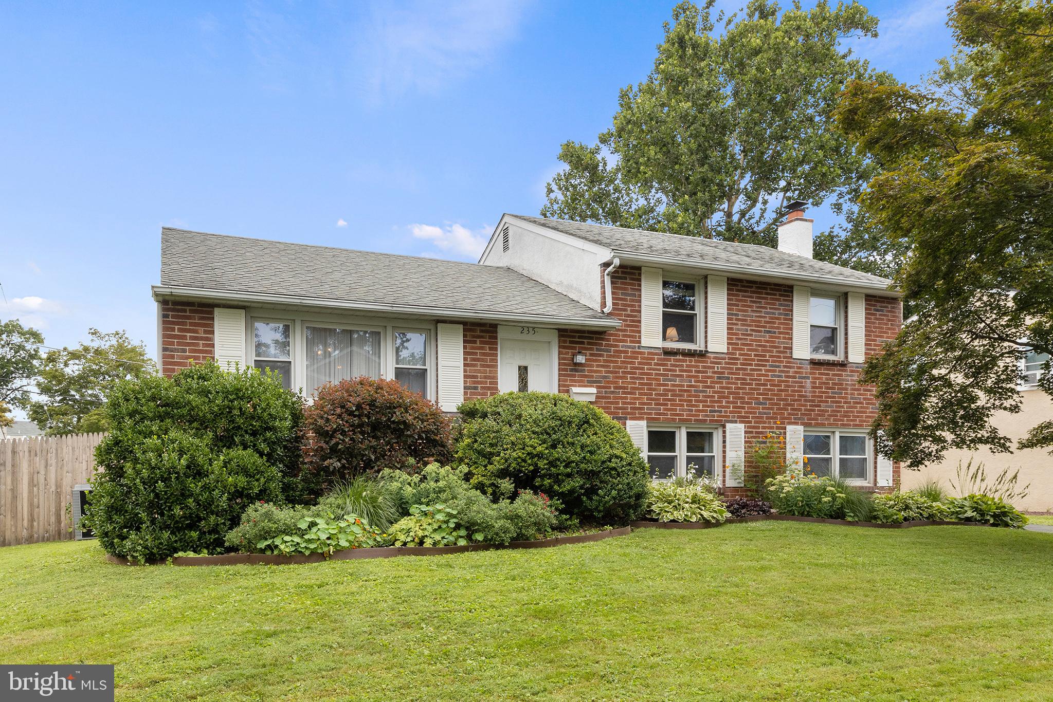 Warm and inviting split level on a quiet, no-outlet street in Springfield Township. This handsome, well-built home is situated on a large, level lot in a great location. Enjoy living in a welcoming community walking distance to a newly refurbished tot lot playground, the heart of downtown Oreland, Sandy Run Park, and the regional rail station. Enter into the bright, open, flexible main living level, bathed in natural light from the large windows and a sliding glass door leading to a gorgeous deck with stairs down to the large fully fenced rear yard (new fence in 2020).  The flow in this house is ideal for entertaining. Enjoy prepping meals in the kitchen, featuring plenty of cabinets and countertop space. The kitchen includes a peninsula island with seating overlooking an inviting living space, which could easily be flip-flopped with the current dining area, depending on your needs. Descend the stairs from the kitchen to the spacious lower-level family room, featuring newer plush carpet, a wood-burning fireplace, and large closet for extra storage. A half bath, utility room with a laundry area, and insulated crawl space providing plenty of storage complete the lower level. Exit out the back door to the large lower brick patio. Upstairs, you’ll find three bedrooms, and a bright, tiled hall bath. Enjoy small-town living just outside the city with this Oreland gem!