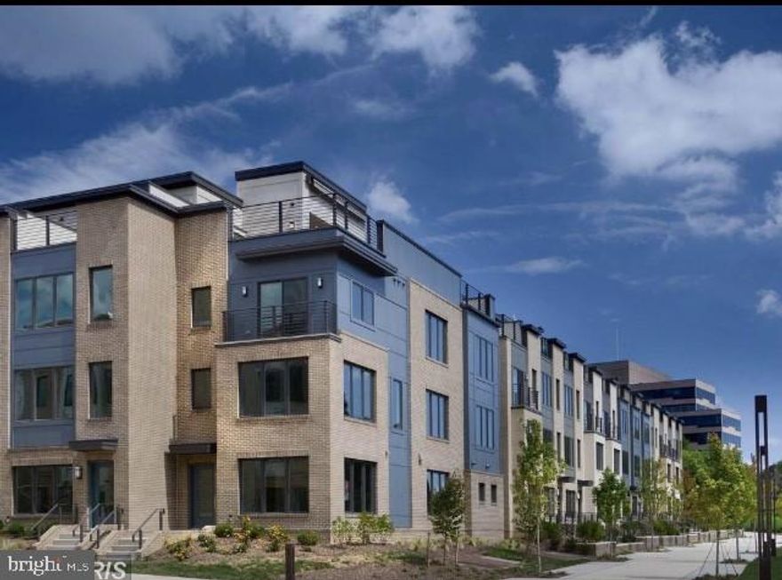 Simply Gorgeous spacious townhome in highly sought-after Montgomery Row townhome  community.  LIKE NEW! This contemporary 4-year young townhome is flooded in natural light and has beautiful hardwood floors throughout, oversized low-maintenance  windows for improved comfort and a stunning rooftop terrace. Its  large open floor plan features a gourmet kitchen with stainless steel appliances and  quartz counters and large center island flowing into spacious living and dining room area. Fresh paint!... Upstairs, a master bedroom with en-suite bathroom and a large walk-in closet. 2 other bedrooms and a hallway bathroom and a laundry room . All closets have built-in shelves.Up to the top floor you'll find a rooftop deck with a Weber gas grill and awning on top. . Au-pair suite on the ground level. All this plus a  2-car garage, additional parking on the premises (with a permit) and for-fee  parking spot in the parking garage. Wonderful location -   minutes to Montgomery Mall, Wildwood shopping center, Grosvenor Metro and 270/495. Close to Cabin John park.  Top Rated Schools! Only 10 min drive from NIH. NIH Shuttle bus comes to the neighborhood (stops by the pond).