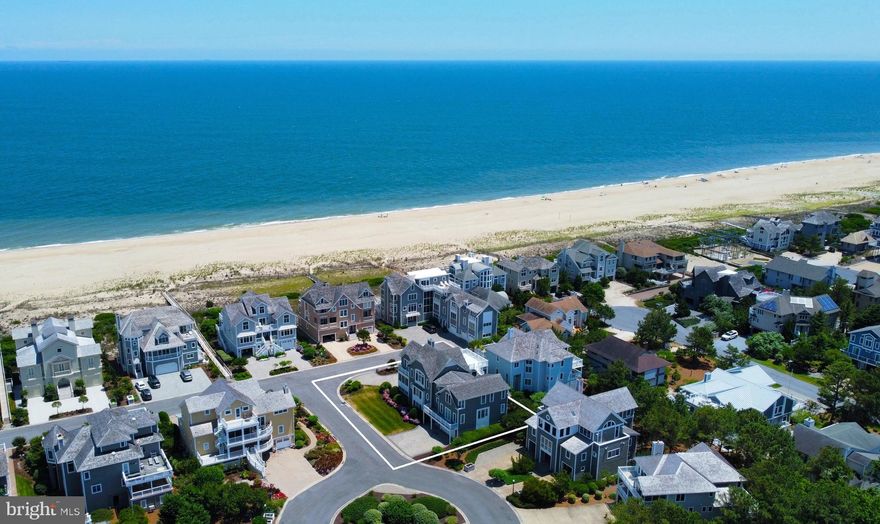 Luxurious Oceanside retreat located just 1 home off the oceanfront where coastal style meets elegance. Custom built with all the fine finishes and features expected in a home of this caliber, including an elevator, and offered with high quality furnishings throughout. This stunning home features a desirable inverted floorplan, allowing for ocean views from the impressive great room with soaring ceilings and an incredible gourmet kitchen designed with entertaining in mind, featuring an expansive center island with dual sinks, multiple dishwashers, restaurant quality appliances, and a separate wet bar next to the dining area. Trifold glass doors open to combine the indoor entertaining space with the oversized screened porch and deck to create the ideal layout for large gatherings or just to enjoy the ocean views and breezes. The grand primary suite is just off the great room with a spa-like bathroom including laundry, as well as a spacious library or office with it’s own full bathroom. The middle level features a large additional family room, 6 generously sized bedrooms, 5 full bathrooms and laundry room. The lower level offers additional living space with a large gym with a sauna and tiled shower as well as a game room.  Additional conveniences include smart home technology, custom built in cabinetry, laundry on every level, multiple outdoor showers, oversized 2 car garage, and utility room. Situated just steps to one of the most highly coveted private beaches on the Delaware Coast, on a large corner lot in the gated community of Ocean Breezes with a pool.  Rarely are homes of this caliber offered for sale!