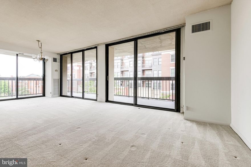 Desire one level living with an oversized outdoor living space and natural light?  This is it!    Sun-filled  end unit with a large wrap around balcony at The Alexandria House is waiting for it's second owner. Two garage parking spaces convey with this unit.  This 2BR/2BA end unit with 1300SF of living space  is being sold "as-is."   Fresh paint throughout the condo and carpets have been professionally cleaned.  Just four blocks to the Potomac River,  steps to grocery and dining right out your front door.   Enjoy your rooftop pool, dining, party room and watch the fireworks with your neighbors!