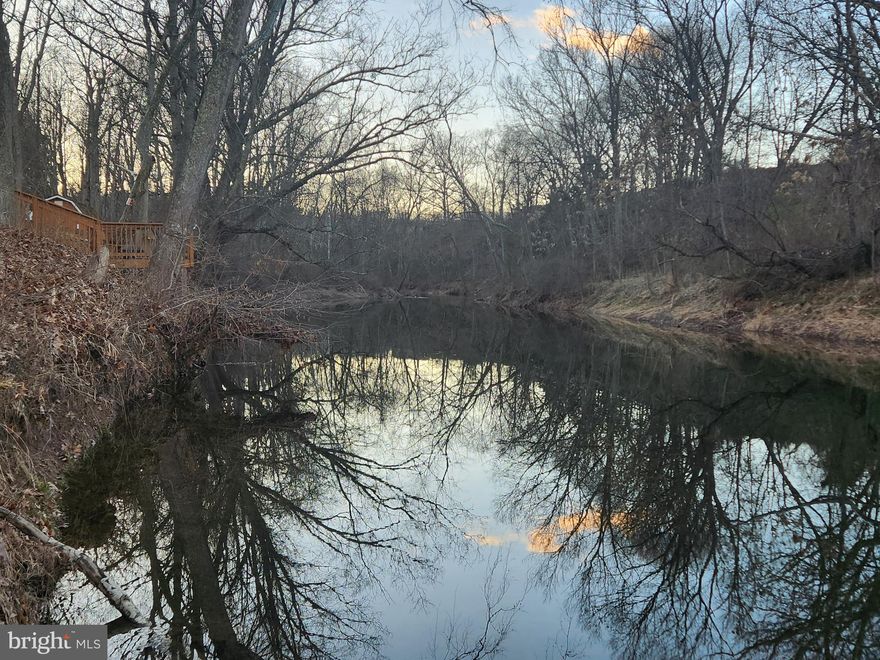 Rare riverfront opportunity.  Wake up in the morning  and have your coffee on the deck by the water and enjoy the wildlife or jump in. This is a newly renovated mobile sitting on almost 2 acres, on the bank of the North River,  featuring two bedrooms, two newly renovated bathrooms (2023), HVAC unit replaced and roof coated in 2022, new paint,  and new flooring (both 2023). The wraparound deck and 12x28 screened-in porch offer peaceful enjoyment of nature, with room to entertain family and guests for cookouts, fishing, swimming, or canoeing in the  swimming hole that spans the rear boundary of the property. There’s ample parking and a separate building with electricity and ventilation that could be used for storage or as a studio.