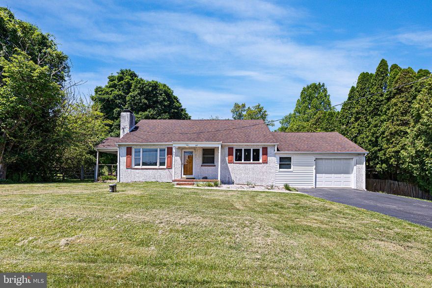 Welcome to 27 Wedgewood Rd in Newark!  Nestled just outside the city limits with no HOA restrictions, this charming move-in ready ranch offers the perfect blend of comfort, space, and privacy.  Step inside to an inviting open-concept layout featuring the living room, dining area, and kitchen, ideal for both everyday living and entertaining.  The kitchen is filled with natural light from a large triple window and features recessed lighting, pendant fixtures, a double-bowl sink, and abundant cabinet and counter space.  The cozy living room showcases a classic wood-burning fireplace with brick surround, built-in cabinetry, and original hardwood floors waiting beneath the carpet.  The main level also includes three generously sized bedrooms and a full bathroom.  Just off the living room, a spacious covered porch creates the perfect outdoor retreat for relaxing or enjoying peaceful evenings.  Upstairs, a huge finished bonus room provides endless possibilities for a home office, playroom, guest space, or hobby area. The basement offers a laundry area, built-in workbench, and plenty of additional storage space.  Conveniently located off the kitchen, the oversized one-car garage features a WiFi-enabled lift and direct access to the rear yard.  Outside, you’ll find a large wooden deck overlooking the private countryside setting with a fenced in rear yard.  Recent updates provide added peace of mind, including a new well and septic system in 2013, roof replacement in 2010, HVAC system in 2015, updated electric panel in 2000, refrigerator replaced in 2023, and a new water heater installed in 2026.