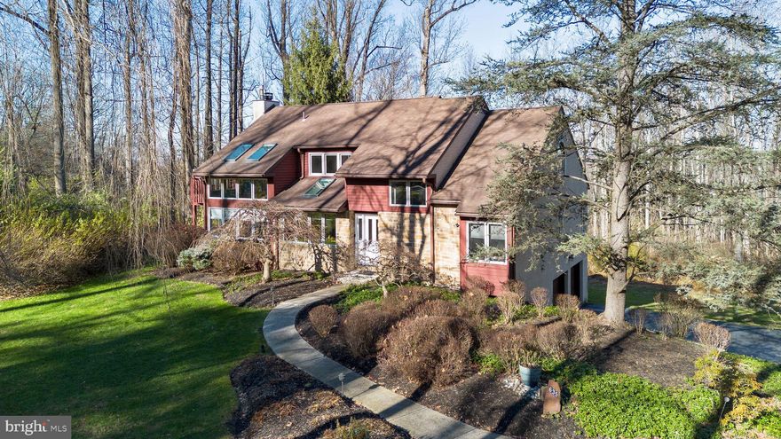 Nestled within the exclusive Eagles Nest enclave in Miquon, Whitemarsh Township, 635 Harts Ridge Road offers a rare opportunity to enjoy serene privacy and a strong connection to nature, all while remaining close to the area’s most desirable destinations. This wooded retreat spans 2.2 acres of mature trees and gentle terrain, creating a quiet, private haven just minutes from Chestnut Hill, downtown Conshohocken, and the Miquon train station for an easy commute to Center City Philadelphia.

This 2,675-square-foot contemporary residence features clean, modern lines and a layout that maximizes natural light and seamless indoor-outdoor connection. The main level offers an easy, open flow for everyday living and entertaining, with a sunlit kitchen featuring generous counter and cabinet space and an adjoining breakfast room. The main living area and formal dining room open to a deck overlooking the woods, creating a peaceful backdrop. A den and sunroom off the kitchen add flexibility and charm. Two bedrooms and a full bath complete this level.

Upstairs, the primary suite serves as a serene retreat with a private deck and a luxurious en suite bath featuring a soaking tub, glass-walled shower, and abundant counter and storage space. A second upstairs bedroom can function independently or as an extension of the primary suite—ideal for an office, workout space, or dressing room.

A full basement with walk-out access to the back yard provides ample storage and flexibility, while the attached two-car garage and circular drive add everyday convenience. A whole-house generator offers peace of mind during power outages. Public gas, water, and sewer utilities ensure modern comfort.

Eagles Nest residents enjoy exceptional access to the outdoors, including the Schuylkill River Trail and Wissahickon Valley Park’s 1,800 acres of forests, creeks, and trails. Nearby amenities include the historic Wissahickon Ski Club and Ashford Farm’s equestrian offerings. Conshohocken’s restaurants and cafés, King of Prussia’s shopping and business centers, and major transportation routes are all close at hand. Located within the highly regarded Colonial School District, 635 Harts Ridge Road offers peaceful, nature-immersed living with everyday conveniences just minutes away.
