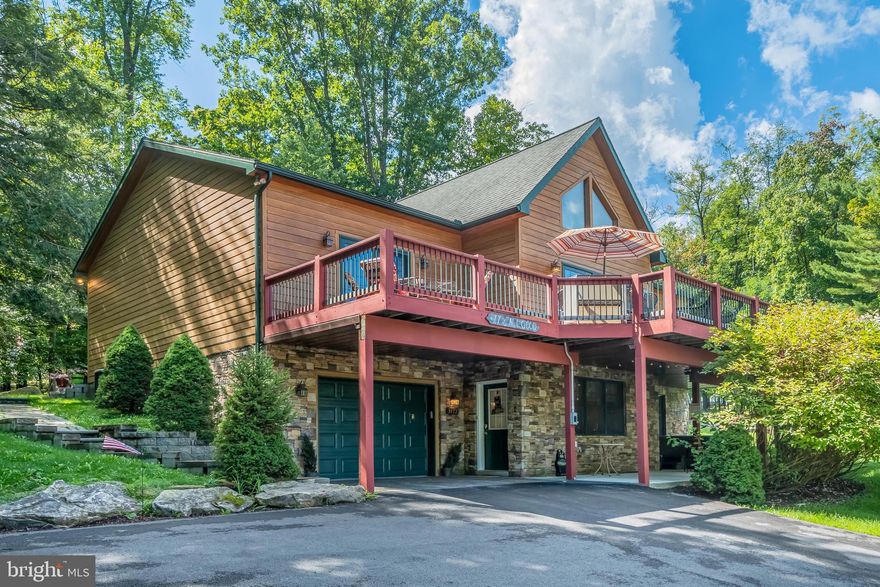 Situated in the sought after area of Lake Shore Drive is this expansive contemporary home with lake views! Built in 2007, this residence boasts five en suites, two stone propane fireplaces, hardwood flooring, granite countertops and a great laundry room. The heart of the home is the open concept kitchen/dining/living room area, making it ideal for everyday living and entertaining. Two levels of living space offer plenty of room for family and friends. The outside space is also very pleasing with a rear yard patio/firepit/grilling area, a lower-level patio with a hot tub, and great front deck where you can enjoy views of Deep Creek Lake. This home is an established rental, but it would also be an ideal permanent residence. You are within minutes to Wisp Ski Resort, restaurants and grocery stores. Call today to preview!