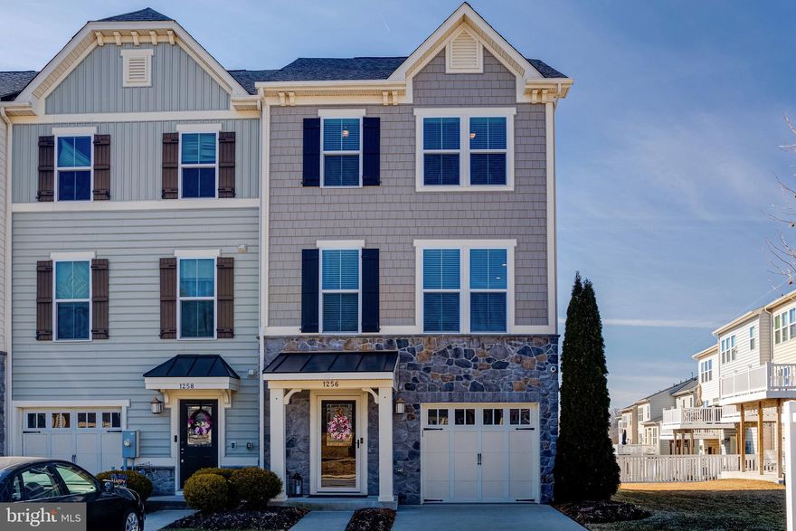 Welcome to this fully upgraded modern 3 bedroom, 2.5 full bath end of group townhome in the highly desired Magness Mill neighborhood, just built in 2015!  This home has been meticulously cared for and upgraded with all the bells and whistles.  Pull into the one car garage or park in the two car driveway and enter in through the covered porch.  Walking into the front door brings you to the first floor with high end wood flooring throughout, a powder room to the left and garage access to the right.  A short hallway leads to a living room area with a gorgeous custom stonework fireplace and french doors that open out onto a newly poured concrete patio that overlooks the fully fenced rear yard and woods beyond.  There is a large open community space to the right of the house for even more play room and another just across the street.  This floor and every other floor has custom crown molding throughout and retractable screen doors on all rear doors.  A mechanical closet here houses the HVAC system, tankless hot water heater and newly installed radon remediation system.  Taking the stairs to the main level brings you to another level with wood floors throughout with a large living room to the left and a kitchen/dining room combo to the left.  This beautiful kitchen comes with granite counters, bar and large island, a backsplash, custom soft close cabinetry with under cabinet lighting, a pantry and all upgraded stainless appliances.  There is a dining room just off the kitchen and French doors that lead out onto the trex deck.  There are custom blinds throughout, 9 foot ceilings on all floors and trim on every level.  Taking the stairs to the third floor brings you to a modern full bath in the hallway with granite vanities and custom tile, and a deep laundry closet with custom shelving.  Also on this floor are three bedrooms, one of which is the owners suite with 10 ft tray ceilings, a walk in closet and private full bath.  The owners bath is modern and upgraded with granite counters and custom tile walk in shower.  This home also comes with a hardwired state of the art security system with three exterior cameras.  This home is a masterpiece and a must see!