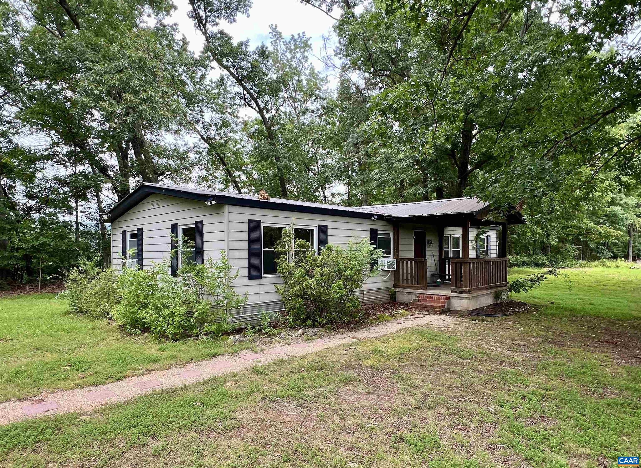 Located in the desirable Western Albemarle District, this Batesville property 2.29-acre property offers a fantastic opportunity to fix up the existing double-wide home or build new. The lot features an existing well and septic system, and has been recently perced?saving time and expense for future development. The current home is a 3-bedroom, 2-bathroom double-wide with several outbuildings on the property. While it will likely not qualify for government financing, it?s an excellent candidate for a cash purchase or land loan. Enjoy peaceful surroundings and scenic mountain views, along with the convenience of being in Albemarle County. A great investment for those looking for space, potential, and location.