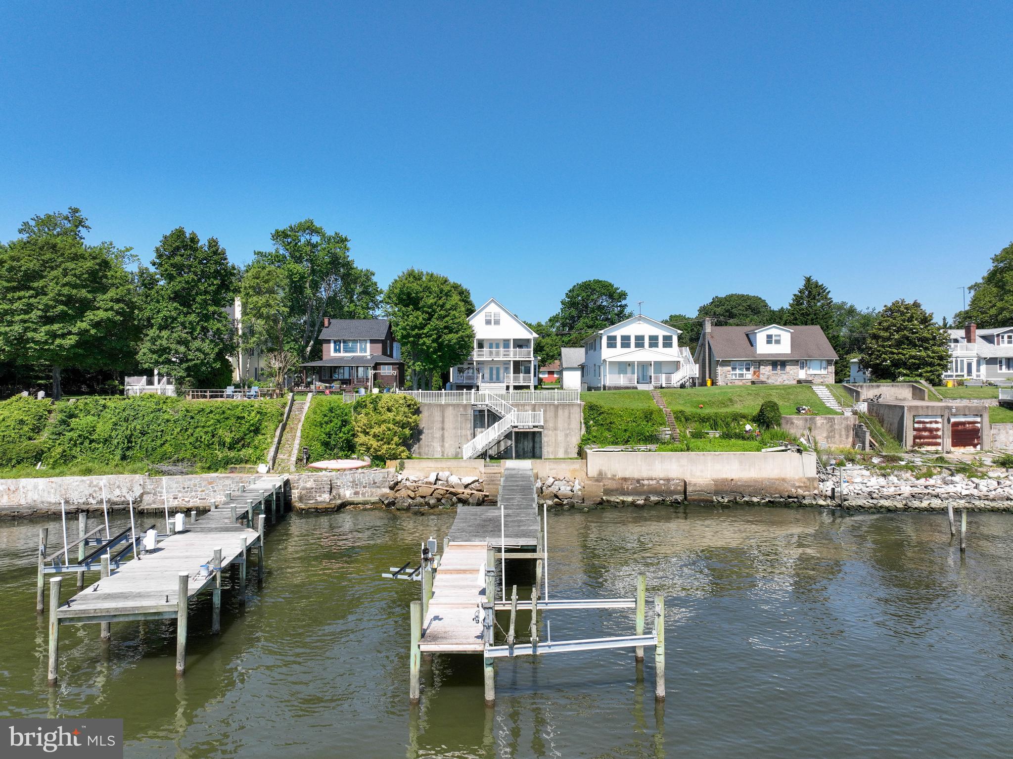 Welcome to your dream waterfront retreat! 8227 Bayside Dr is located in Pinehurst, nestled on the shores of the Chesapeake Bay and Bodkin Creek. This well-maintained home offers the opportunity to have cosmetic improvements made to a very large, modernized structure. The home has approximately 3400 sf of living space with room for everyone. Spectacular views and sunrises over the famed Chesapeake Bay are astounding! Multiple decks and a level lawn elevated beautifully above the water provide a variety of options to enjoy the views and embrace the beauty of the natural surroundings.
Thoughtfully expanded and renovated (2006), the home has an open floorplan with beautiful bamboo flooring throughout. The waterfront family room with a fireplace is the perfect space to relax and enjoy the never-ending views of the horizon. The adjacent dining area has those glorious water views for every meal. Step out to the waterside deck for an alfresco meal or BBQ and enjoy the Bay breezes. The kitchen features a built-in bench perfect for eating in and a large pantry. The main level primary suite is very spacious with a private full bath and easy access to the main level laundry closet. The second level is defined by convenience and comfort with a huge waterfront room with a private full bath that offers great flexibility to serve as a second primary suite, home office, or second living space. The 3rd and 4th bedrooms on the second level are generously sized as well and share a jack and jill full bathroom. On the top level of the home, you'll discover a fantastic bonus space. This space is perfect for hosting overflow guests, creating a playroom, or keeping a private office space with a poised, birds eye view of the beautiful Chesapeake Bay. Gorgeous Downs Park is within walking distance and offers picnic pavilions, paved, wooded walking trails, and summer concerts. Live the Maryland waterfront lifestyle and take advantage of one of the best boating destinations the East Coast has to offer! In just 30-50 minutes, boat to Annapolis, Rock Hall, the Magothy River, Kent Island and Baltimore. Or stay close to home with multiple protected anchorages to enjoy the sunset. Located just 5 miles from Gibson Island Country Club, with an easy commute to Baltimore, Annapolis, or DC, the prime location is perfect for full-time living or a second home. An ideal waterfront sanctuary that marries the tranquility of coastal living with the easy access to multiple metropolitan areas awaits you! Call today!