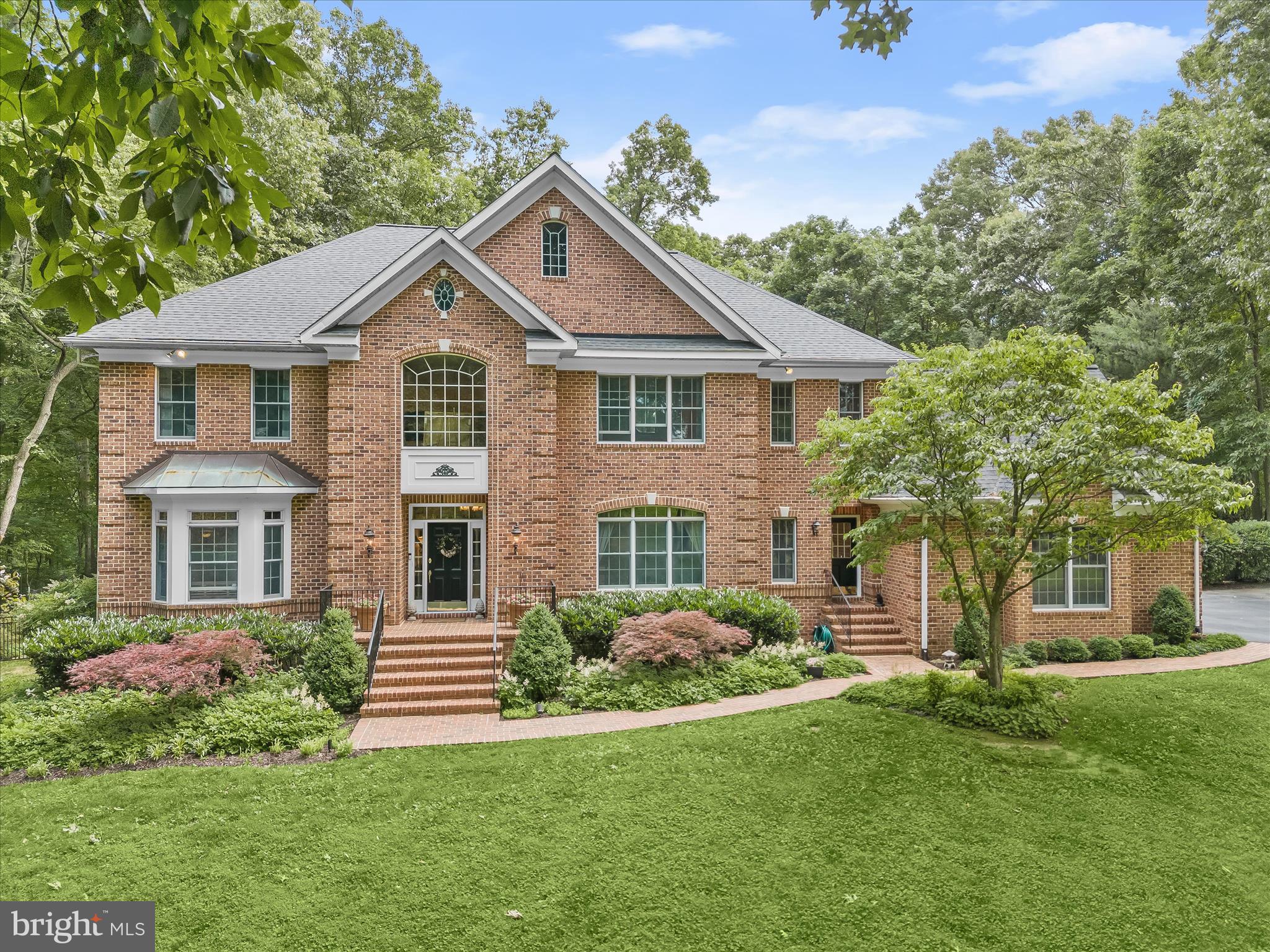 Gorgeous Outdoor Escape Meets Thoughtful Indoor Luxury
Escape to serenity in this all-brick custom home that presides over 3.5 majestic acres backing to Western Regional Park. The property is set back on a quiet cul-de-sac with a lush front lawn and serpentine brick walk along the front of the home accented with exterior architectural lighting.
Inside, hardwood floors escort you through a thoughtful floor plan, perfect for entertaining with a two-story foyer flanked by living and dining formals for special occasions and celebrations. The extended foyer unfolds into the central family room where family and friends can gather informally. A cozy stone wood-burning fireplace with heatalater stands ready for cool evenings while tall windows, transoms and a balcony invite views of the glistening pool and rear gardens. Designed with lifestyle flexibility, the main level features a full bath and adjacent study with a closet that could double as a bedroom for one-level living as needed.
Family, friends and foodies will enjoy a spacious gourmet chefs kitchen upgraded in 2023 with new stainless appliances. Timeless wrap-around cabinetry and a walk-in pantry encircle the center island and breakfast bar with seating for four. Sun light streams into the kitchen and adjacent breakfast room through windows and an atrium door that opens to the dining patio on the rear side. A mud room with shoe cubby has a secondary entry door on the front side, and there is also a secondary back stair adjacent to the kitchen and breakfast room for quick and easy access to the upper level.
Upstairs, there is a gracious primary bedroom, separate sitting room, walk-in dressing closet with organizer built-ins, and a luxurious upgraded primary bath. The upper level is completed by three additional en-suite bedrooms, laundry and a ready to finish bonus attic storage room.
The walk-out lower level is partially finished with full daylight windows, and an atrium door to a paver patio, and rear oasis. The heated in-ground pool is surrounded by paver patios, a gazebo, and gorgeous perennial sun gardens. Specialized landscaping at every turn is rich with lavish, yet low maintenance perennial gardens for sun and shade, flowering trees, and stone beds. Come home to luxury and escape to serenity every day!