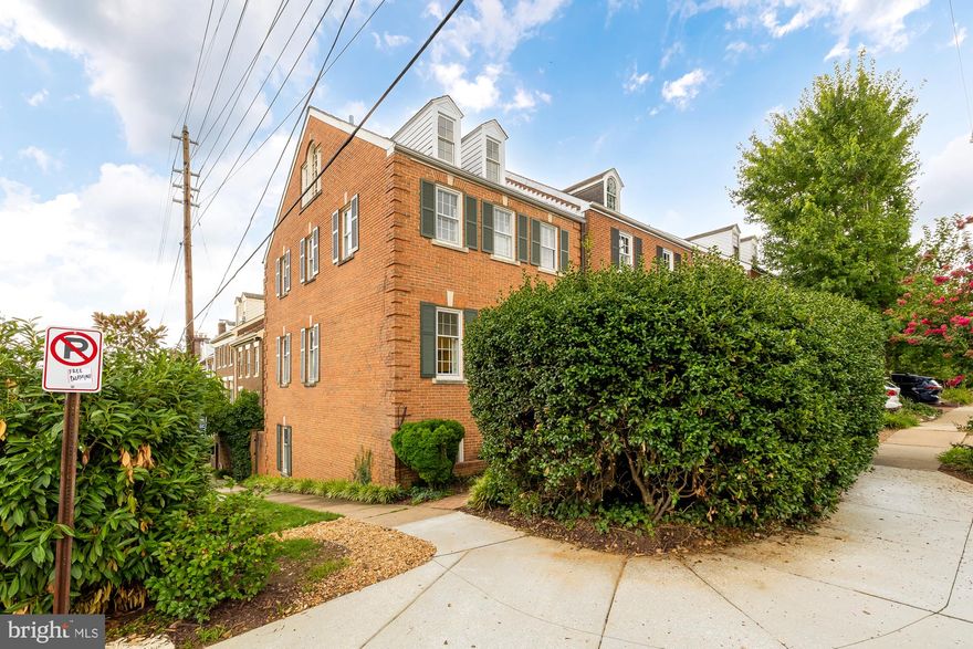 NEW LISTING! Open Tuesday, August 6, 11:30-1:30 with lunch provided by First Savings Mortgage. Welcome to this enchanting 2700+ sf, end-unit, Pommander Row townhouse located just one block to the Potomac River! This stately, and rarely available 4BR/3.5BA brick home overlooks spectacular Windmill Hill Park in the sought-after southeast quadrant of historic Old Town Alexandria. Sunlight streams through the many divided light windows from three exposures, drenching the home in sparkling natural light and showcasing Potomac River views from the 2nd and 3rd floors. The park-side setting of this home is truly special: open spaces, big sky, shade trees, spectacular river views and picnics you've always dreamed of! Short walk to King Street restaurants and shops, yet set in a quiet neighborhood surrounded by American history, and some of the most expensive homes in Old Town. Halloween in this neighborhood is legendary! The private garden entrance features a charming brick walkway and is set back from the street, sheltered by mature plantings and lush trees. Once inside, there is a foyer entrance with rich hardwood floors and a convenient entry nook for shoes, jackets and keys. Custom millwork by the locally-renowned Rust Construction Company includes built-in cabinetry and detailed chair rail and crown molding. The solid wood banister and newel post were reclaimed from Burke & Herbert, Virginia’s oldest bank. 
This home boasts an ideal floorplan with a recently updated powder room on the main level, a large family room with dining area, a romantic wood-burning fireplace, tall ceilings, recessed lighting, and beautiful built-in cabinetry. The spacious kitchen features granite countertops, stainless steel appliances, a desk area and tons of storage! On the second floor, there are two bedrooms and two full bathrooms. The 3rd bedroom is on the top floor, and features a dedicated HVAC wall unit, vaulted ceilings, new carpet, plenty of storage and beautiful river views. The top floor would also make a spectacular home office.
The 4th bedroom is on the lower level along with the 3rd full bathroom, family room with second wood-burning fireplace, laundry room with stacked, front-loading washer and dryer, and walk-out to a delightful private stone terrace. The terrace features thoughtful hardscaping, landscaping, and raised bed planters, and offers easy gated access to Gibbon Street, which is perfect for dog walking and bicycles, a bonus because this home is less than a block from one of Old Town’s largest, free-run dog parks, as well as the wonderful bike path that runs through Old Town, from the National Mall in Washington, DC all the way to Mount Vernon. An unbeatable location, a smart floorplan that lives large, and an address to be proud of. You will love living here!