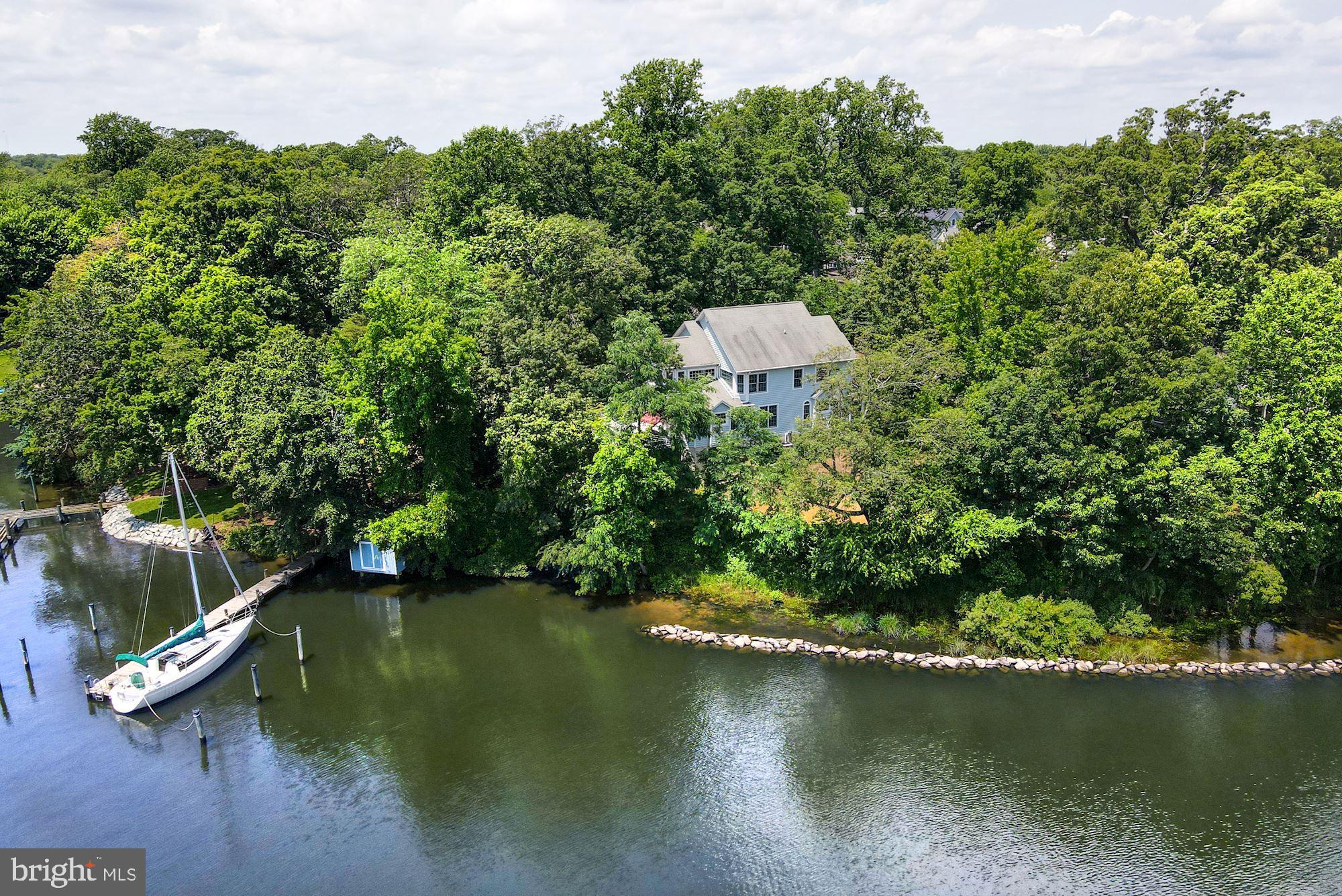 Sited on back Creek with over 200’ of water frontage, this beautiful residence is highlighted by an open sunbathed floor plan and deep-water pier. The main level features a gourmet eat-in kitchen with breakfast area, a great room with gas fireplace opening to a large rear deck, formal living room with gas fireplace, dining room, powder room, and mud room to garage. The second level offers a large sunbathed primary bedroom with generous primary bathroom and a walk-in closet. The second level is completed by a second bedroom with ensuite bathroom, 2 additional bedrooms, a bathroom, and laundry. The expansive walk-out lower level offers a recreation room, media area, bonus room, full bathroom, and ample storage. The deep pier offers 5’ MLW and storage shed on the water. Back Creek offers easy access to Severn River and the Bay. Eastport and downtown Annapolis are 5 minutes away.