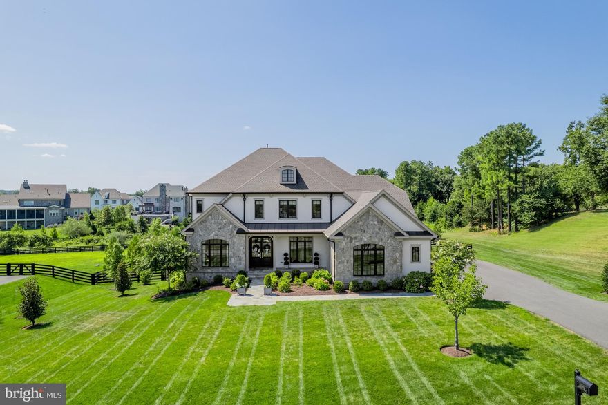 Welcome home to this custom-built masterpiece by Novella Custom Homes, where timeless craftsmanship meets modern luxury in one of Northern Virginia's most prestigious gated communities. Every detail of this residence has been thoughtfully designed to combine sophistication, comfort, and function creating a home that is as elegant as it is comfortable.

From the moment you arrive, the exterior makes an impression with stone, stucco, and Hardi-plank finishes, while a welcoming walkway leads to a covered front porch and a grand foyer. Inside, wide-plank hardwood floors sweep across the main and upper levels, setting a warm yet refined tone. To one side, a handsome library with built-ins provides an inviting retreat, while the opposite side hosts a formal dining room with direct access to the chef’s kitchen.

The kitchen is nothing short of a showpiece. Anchored by a massive island with quartz countertops and abundant seating, it features custom inlaid cabinetry and professional-grade Wolf and Sub-Zero appliances. Sunlight pours into the adjoining breakfast sunroom, which opens to a deck complete with a gas fire pit - an ideal setting for outdoor entertaining. Just beyond, the family room blends elegance and comfort with built-in shelving and a cozy fireplace, while a tucked-away office offers a quiet space to work from home. A thoughtfully designed mudroom with brick-laid tile, cubbies, and sink adds practicality and charm near the family-entry to the home.

Upstairs, the primary suite is a serene sanctuary with a beautiful, tray ceiling, built-in shelving, and two walk-in closets with custom systems. The spa-inspired bath offers dual vanities, a soaking tub, and a walk-in shower. Three additional bedrooms, each with its own en suite bath and walk-in closet, provide comfort and privacy for family and guests. A spacious laundry and sorting room completes this level with everyday convenience in mind.

The lower level was built for entertaining. The expansive rec and game rooms open to a patio and a flat backyard - perfect outdoor play, evenings around the fire pit, or even future pool plans.  A full wet bar, an incredible media room, a fifth bedroom with full bath, a bonus room ideal for a gym, and a large storage room complete this versatile level. The oversized three-car side-load garage adds further convenience and space.

All of this comes with connectivity that feels worlds away yet close to everything. Just 20 minutes from Dulles International Airport and the Silver Line Metro, you’re also moments from the shops, dining, and wineries of Leesburg and Middleburg.

Beyond the home, life at Creighton Farms offers an unparalleled lifestyle. Anchored by an 18-hole Jack Nicklaus championship golf course, the community boasts indoor golf bays, tennis and pickleball courts, resort-style pools, a world-class wellness center, and a clubhouse offering fine dining and vibrant social events. Multiple membership tiers allow you to curate your experience.

This is more than a home - it’s an invitation to live beautifully in one of Northern Virginia’s most prestigious private communities. Don’t miss the chance to make it yours!