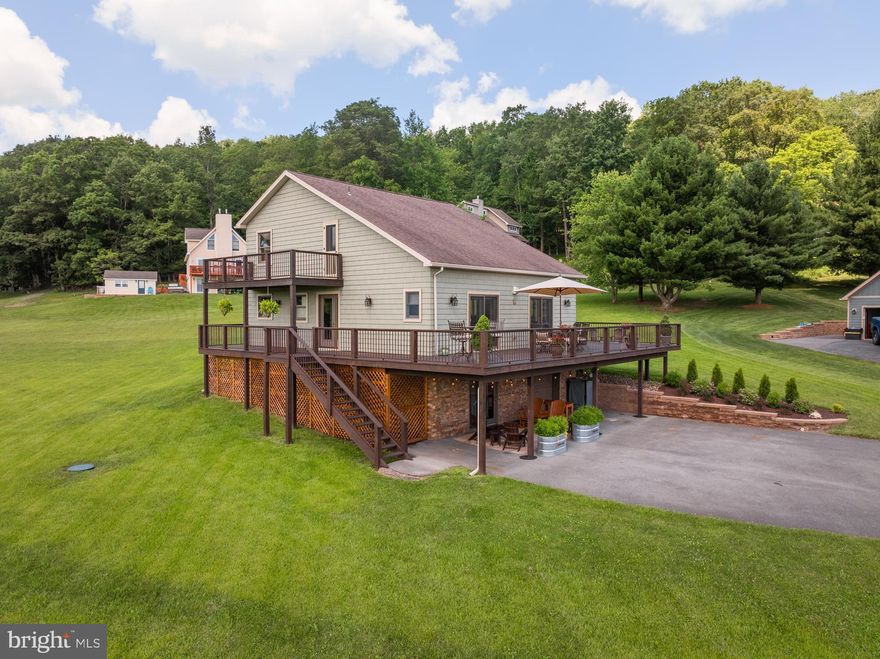 Impressive lake-access home located in the desirable Paradise Ridge community. This modern retreat showcases breathtaking views of the mountains and Deep Creek Lake. From the moment you step inside, you'll be welcomed by a warm, inviting atmosphere featuring wood-accented ceilings, luxury vinyl plank flooring, quartz countertops, and an abundance of natural light through expansive windows. With three ensuite bedrooms and four full bathrooms, there’s ample space for hosting family and friends in comfort. Outdoor living is just as impressive, with a spacious wraparound deck, a covered side porch, and a lower-level patio—perfect for relaxing or entertaining. The large yard, paved driveway, and built-in storage under the deck add even more convenience. The patio is also prepped and ready for a hot tub. Offered move-in ready—schedule your private showing today!