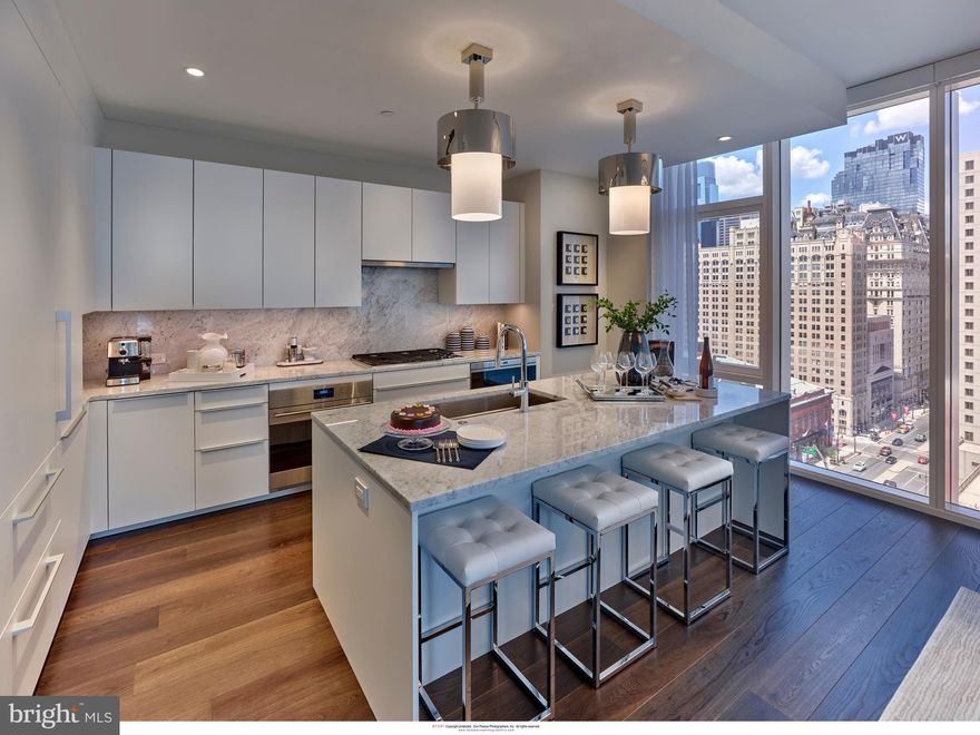 Arthaus, a commanding new residential high-rise in Philadelphia’s performing arts district, presents Unit 1902:  A stunning 2-bed, 2-bath, 1,598 SF single-level residence with City Hall and skyline views priced at $1,400,000.  

This maintenance-free, move-in ready, home offers high-end interior design, resort amenities and white gloves services. Tax abatement is available. Whether you’re a busy professional, retiree or globe trotter, 1902 is a MUST SEE!

Arthaus impresses from the moment you enter.  The tall solid wood door with elegant hardware sets the stage, leading to a spacious, light-filled foyer with the large walk in coat closet and convenient hallway bath and laundry facilities.  The great room offers panoramic views of the city featuring a blended kitchen, living and dining space with soaring ceilings, floor to ceiling windows, wide-plank Havwood flooring and a weather-protected walk out balcony. Drenched in natural light this space is bright, airy, and feels twice its size on paper.

The chef’s kitchen is everything you need for hosting, with a large center island that seats four.  The upper and lower cabinets are polar white matte by Poggenpohl and the countertops Super white quartz with matching backsplash. The high-end, stainless appliance package includes: Wolf, Bosch, Sub-Zero and Asko appliances and door fronts have been fully integrated into the cabinet design for a seamless look.

The primary suite and guest bedroom are on the east side of the condominium.   
The guest bedroom is a quiet retreat for visiting guests with gorgeous mid-town views and walk-in closet. The full bath in the hallway is finished with porcelain Calacatta tile floors, super white quartz countertops, and polar white matte Poggenpohl cabinets. The spacious Owner’s suite is wrapped in 10' floor-to-ceiling windows and features an oversized walk-in closet. A Badeloft soak-in tub, double vanity with Robern mirrors and super white quartz marble, Contempo white marble floors and shower tile, and a Kohler toilet closet complete the best-in-class bathroom package. 

Arthaus is a modern masterpiece crafted by renowned developer Carl Dranoff, designed by Kohn Pedersen Fox and built by Intech Construction.  Its architecture and amenities prioritize wellness and well-being, from the stunning Monet-inspired mosaic in the lobby to the private resort on the 6th and 7th floors, featuring a pool, fitness facilities, spa, salon, pet park, outdoor terraces, lawns, gardens and more.  White glove services include 24-doorman, concierge, chauffeured town car and car valet. 

This home comes with 1 parking license. With the tax abatement annual real estate taxes are approximately $2,710