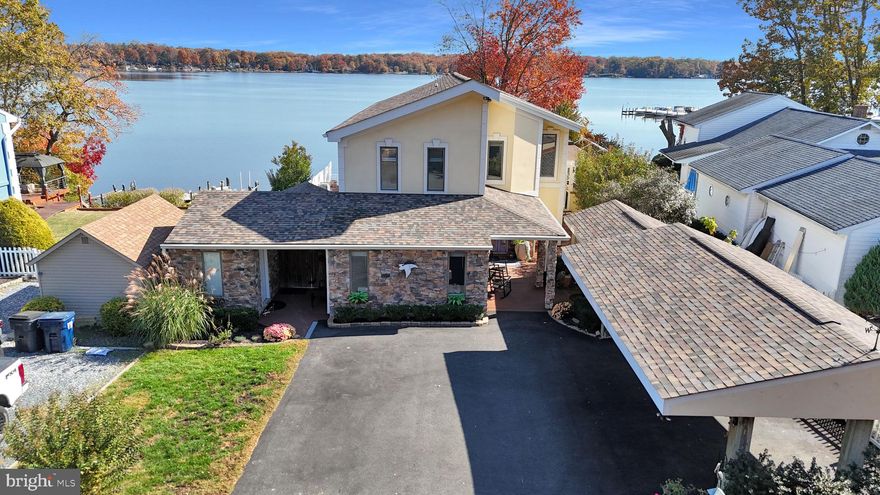 Welcome to your dream waterfront retreat at 4015 East Baker Avenue in Abingdon, MD! This stunning 4-bedroom, 4.5-bathroom home offers  vaulted ceilings, an open floor plan, and a freshly painted interior that exudes warmth and style. A fantastic feature of the home is the heated and cooled enclosed sunroom, complete with a kegerator and grill kitchen, perfect for entertaining year-round. Enjoy the convenience of a first-floor primary bedroom with en suite bathroom, while the second floor boasts another primary en suite bedroom for added privacy and comfort. The lower level features a one-bedroom apartment, ideal for an in-law suite or visiting guests. Outdoors, unwind in the spa with a waterfall, or relax on the deck overlooking breathtaking views of the Bush River. The property includes a 150 ft pier with 4 slips, 2 equipped with boat lifts, plus electric and water service, and a 40 ft catwalk.  A fun tiki bar sits on the catwalk at the pier. Recent updates include a new retaining wall (2023), roof and gutters (2020), dishwasher and refrigerator (2020), upper level HVAC and ductwork (2024), driveway (2020), upper level and first floor bedroom hardwood floors (2022), house freshly painted (2024), staircase, rails and spindles (2024), entry hallway board and batten and vented front porch soffit (2020), primary upper level bath light remodel (2024), remodeled upper-level hall bath (2024), new motor in elevator (2024). With amenities like a 2 fireplaces, a steamer spa shower, and temperature controlled wine cabinet, plus walking distance to the Bush River Yacht Club, and close proximity to APG, I-95, and Bel Air, this home offers the perfect blend of luxury and convenience. Don’t miss this exceptional opportunity!