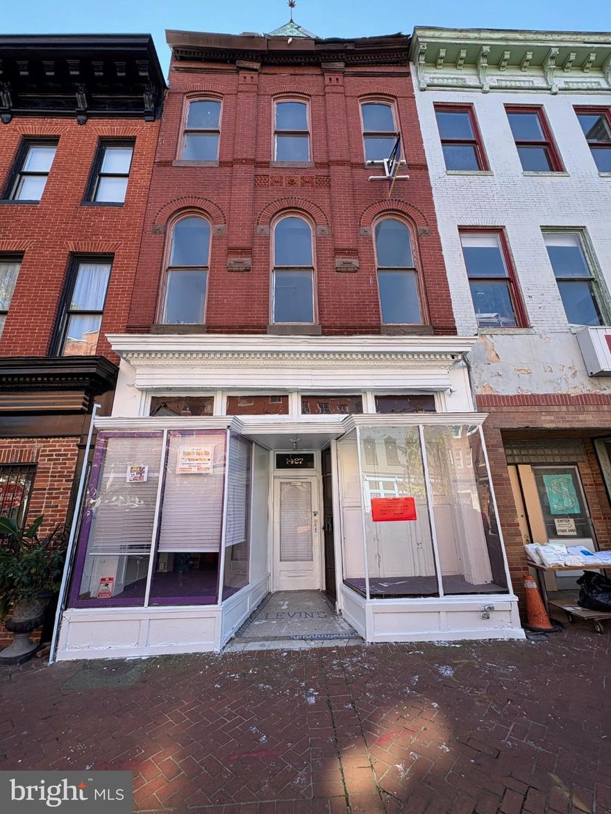 Historic mixed use brick front in rapidly improving commercial district*Beautiful architectural features on this three story multi use building*Building needs cosmetic work throughout to bring it back to it's former glory * Excellent layout consist of a classic storefront on the main floor with two beautiful showcase display windows and an original tin ceiling* The show room retail space is approximately 17'x 30' long* There are two more rooms on the main level that lead to the rear entrance and a half bath*Business operator would most likely use this entrance when coming from the three car detached garage *  There is a separate entrance at to the side of the commercial space entrance that leads to two apartments on the upper floors* The second floor apartment feature a great room highlighted by three tall art deco style windows at the face of the building*these windows allow for an abundance of natural light to fill this grand room*Outstanding for many uses such as a studio , office space or combo living/dining room* Two 15 pane windowed doors lead to a full size eat-in kitchen* A full bath , separate bedroom and potential 2nd bedroom complete this level* The third floor while a little more challenging could provide and excellent living space for any tenant* Get in now while prices are still affordable! Close to Union Square ,UMD Biotech, Bon Secures this area promises to be a vibrant hub for West Baltimore once again* 
" W. Baltimore St. can again become a thriving commercial corridor for the area and the 
city by taking advantage of the existing customer base of residents and workers at 
Bon Secours Health System and the UMB Bio park, preserving the street’s historical character, and building off of existing businesses to develop focused commercial nodes. A revitalized W. Baltimore St. will 
connect neighborhoods and institutions, provide needed goods, services, and jobs to residents, and attract new residents and investments to the area" Property is sold "as-is" Seller will make no repairs* Take a flashlight with you at this time*Electric will be on soon* Separate water heaters and gas and electric meters for each unit* Easy to show !