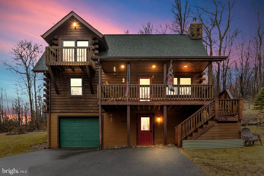 Mountain Magic in Maryland
Tucked away on nearly 7 private acres, this exquisite custom square-log home is a rare find — a secluded mountain retreat just 20 minutes from Frederick and moments from Cunningham Falls State Park.
Every detail of this home has been crafted with intention.  A soaring floor-to-ceiling stone fireplace anchors the open living and dining areas, while warm wood interiors and vaulted ceilings create an atmosphere that feels both grand and deeply inviting. The main level features a bedroom, full bath, and laundry for effortless single-floor living. Upstairs, the primary suite is a true sanctuary — complete with an ensuite bath, custom walk-in closet, and a private balcony overlooking the wooded landscape. Just beyond the suite, a loft perch above the great room makes for an enchanting reading nook with fireplace views below.
The connection to the outdoors is seamless.  A covered front porch, expansive rear deck, and acres of land — partially fenced and ready for pets or livestock — offer endless possibilities with no HOA. Thoughtful additions include an EV charging station, an RV pad, whole-home Generac backup power, and a wood-burning stove for the coldest mountain nights.
A long paved driveway leads to the home, which is completely hidden from the road — offering the kind of privacy that is increasingly hard to come by. The nearest supermarket is just 3 miles away, so solitude never means sacrifice.
Shown by appointment only. Please do not enter the driveway without a scheduled visit. Contact Debbie Hugo to arrange a private tour.