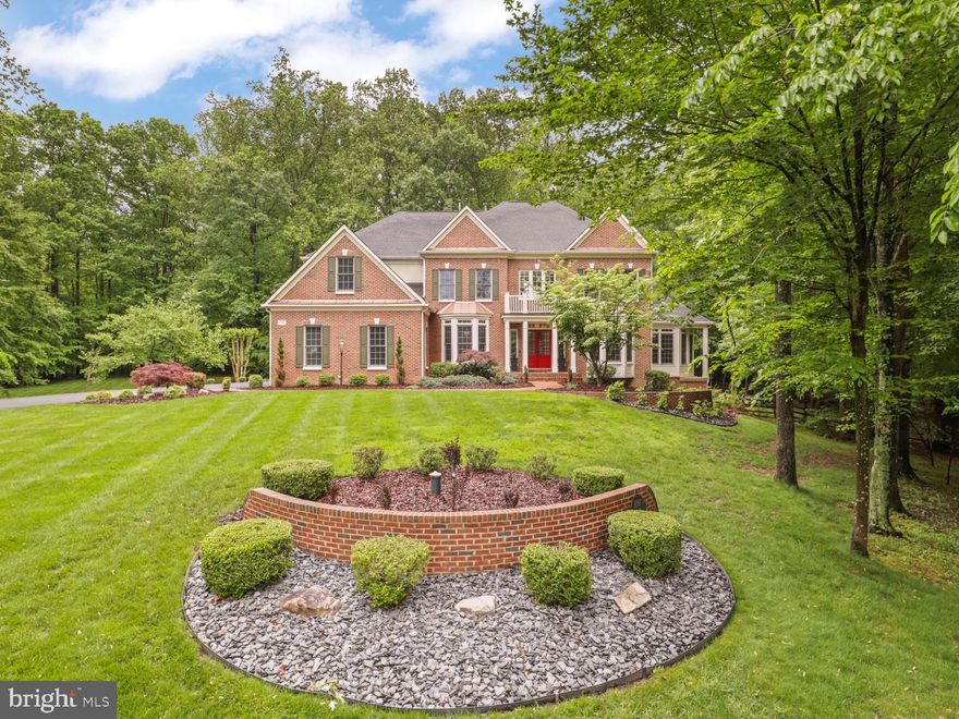 A Private Oasis: Elegant Estate Living on 5.5 Wooded Acres Welcome to an extraordinary Appx. 8284 square-foot luxury residence nestled on 5.5 wooded acres in the prestigious Estates at Roseland, southern Fairfax County. This beautifully maintained home offers a harmonious blend of modern family living and serene privacy, situated on a quiet cul-de-sac away from urban noise. Main Level Features:- Step into a grand two-story foyer with gleaming hardwood floors that flow seamlessly throughout the main level. The heart of the home is a gourmet chef’s kitchen, featuring an expansive center island, Thermador Masterpiece Series appliances with WiFi control, Wolf Designer cabinetry, a custom pantry, designer sinks, and smart faucets (reverse osmosis)—perfect for culinary enthusiasts. The spacious family room boasts a dramatic two-story ceiling and a stunning two-sided gas fireplace, adorned with quartzite stone on one side and limestone on the other, creating a warm and inviting atmosphere for gatherings or relaxing evenings. Enjoy formal living and dining rooms, a sunroom, and a conservatory—ideal for hosting elegant dinners and special occasions. A professional office provides a quiet, inspiring space for work or creative pursuits. Step outside onto an enormous two-level deck with original Trex decking and a screened-in gazebo, perfect for outdoor entertaining. The property also features a heated pool and jetted hot tub with WiFi control, as well as a scenic trail that winds along the creek through the grounds. Upper Level:- Upstairs, the lavish owner’s suite serves as a true sanctuary, offering breathtaking views and ample space to unwind. The spa-inspired ensuite bathroom includes an oversized tub, walk-in shower, and dual vanities for ultimate relaxation. Two walk-in closets and a dedicated dressing area provide exceptional storage and convenience. The upper level also includes three generously sized secondary bedrooms and two additional bathrooms. For added convenience, there are two laundry rooms, including a newly built elegant laundry room on the second floor with smart washer and dryer, custom cabinetry, and a marble backsplash. Lower Level:- The expansive lower level is designed for entertaining, featuring a bright recreation room ideal for gatherings, movie nights, or game days. A private fifth bedroom and full bath offer a comfortable retreat for guests. There’s ample space to create a home gym, media room, or hobby area tailored to your lifestyle. The large utility room hosts a second set of washer and dryer, a state-of-the-art EcoWater water system with smart app, and a UV light water filtration system. A spacious storage room provides plenty of space for seasonal items or additional supplies. This level offers direct access to the outdoor swimming pool, patios, and beautifully landscaped backyard, making indoor-outdoor living effortless. Community & Lifestyle:- Enjoy a relaxing drive through this tranquil, well-designed wooded community every day. The Estates at Roseland offers a peaceful retreat from the bustle of city life, with private outdoor spaces and luxurious amenities for the ultimate living experience. Experience the perfect blend of elegance, comfort, and modern convenience. Schedule your private tour of this exceptional residence today!