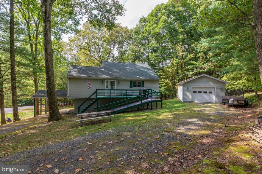 Cozy but spacious Home in Lake Wynonah.  Pride of Ownership is evident!  From the up to date country kitchen, to the finished basement... this home is move in ready for you!  Cathedral Ceilings in the Living Room with Sliding Doors to the back deck.  The front deck has lots of space too, and a full ramp for easier access.  One car detached garage, plus carport space.  The home also features a brand new septic system (3/2019) and upgraded 200 AMP service(1/19).  Fresh paint, new heaters, and the chimney has been cleanedThis place is ready to go!