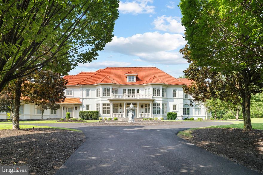 Welcome to an exceptional private estate offering resort style living in the heart of Great Falls! Set behind secure gates on more than five and a half acres, this Mediterranean inspired residence has been completely transformed with extensive brand new upgrades throughout, creating a turnkey luxury retreat ready for immediate enjoyment.
The home spans over 12,000 square feet of newly updated living space designed for both everyday comfort and large scale entertaining. The open and airy floor plan flows effortlessly, ideal for multigenerational living and elegant gatherings. Every major system and finish has been thoughtfully replaced or upgraded, delivering the peace of mind that comes with essentially new construction. 
At the center of the home is a massive, yet cozy family room, drenched in daylight with floor to ceiling windows, a soaring stone fireplace extending to the ceiling that serves as a stunning statement piece, and a completely brand new chefs kitchen equipped with top tier Miele appliances, a cafe style gas range, quartz countertops, and custom cabinetry. This space is designed to impress while remaining highly functional for daily use and entertaining.
Also on the main level is a one of the two primary suites, a grand formal dinning room, an elegant formal living room, along with a beautifully renovated sunroom filled with natural light that creates the perfect space for morning coffee, reading, or relaxing year round. 
And lastly, a brand new laundry and mudroom, thoughtfully designed with custom cabinetry, modern finishes, and functional storage.

The upper level features a second expansive primary suite, along with four additional en suite bedrooms, all offering walk in closets and beautifully redesigned bathrooms. Each bath showcases brand new designer finishes including full slab marble showers, custom vanities, and modern fixtures inspired by luxury spa living.

The walk out lower level offers a versatile entertainment experience with a private home theater, a large home gym that can easily be converted to a 7th bedroom, a full bath, expansive recreation space and tons of storage. 

Outdoor living is equally impressive with a heated saltwater pool, newly constructed basketball court, a pond, extensive new hardscaping, and a flagstone patio ideal for outdoor dining and gatherings.
The circular driveway provides ample parking for over 25 vehicles in addition to the three car garage, making entertaining effortless. 
Major improvements include six new HVAC systems, new roof insulation, a newly paved driveway, and a newly added  generator installed in 2026.
This is a rare opportunity to own a fully updated luxury estate where nearly everything is brand new. A true destination property offering privacy, sophistication, and resort level amenities in one of Great Falls most prestigious settings.
Enjoy prime Great Falls location,  with just minutes to Tyson's corner, Route 7, and 495! And just  0.7 miles from Great Falls Village, home to popular restaurants and coffee shops, grocery shopping and other shops for everyday convenience.
Schedule a tour today to fully appreciate the craftsmanship, scale, and setting of this remarkable home!
Square footage information is deemed reliable but not guaranteed.